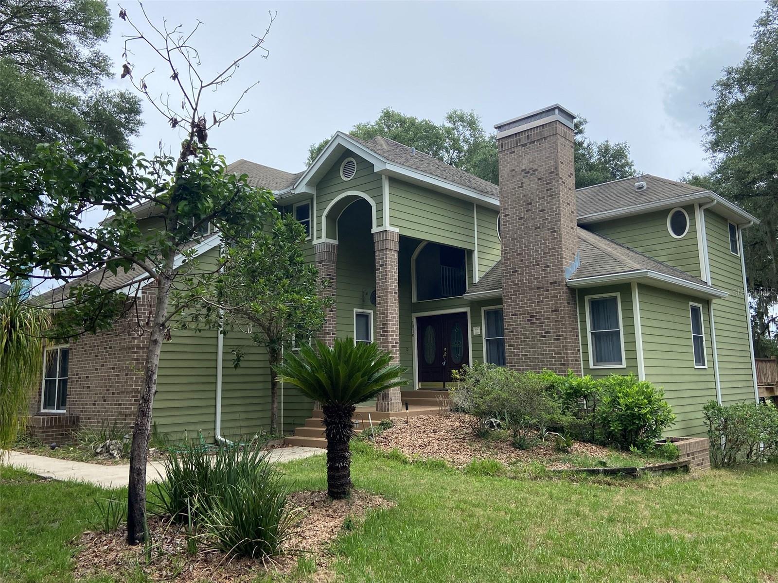 This lakefront home is in the BEST location in Apopka. The one-of-a-kind Wekiva Glen subdivision, with its single gated entrance, makes the perfect walking or bicycling neighborhood. This three story, traditional home on 1.58 acres has 4 bedrooms, 2½ baths, two fireplaces, a second and third floor deck and a 700 sq ft finished walk-out basement onto a concrete patio.  Built in 1990, the shell of the house (excluding a portion of garage) from top down was replaced in 2009:  2 chimney caps, roof shingles, roof fall protection system, aluminum soffit / fascia, moisture barrier, new Hardie Board lap siding, new French doors, and new paint.  The AC air handler and condenser unit was replaced in 2022.  Cozy rooms define this house with a grand entry, staircase, vaulted living room ceiling and built-in cabinets in the family room.  The air conditioned, walk-in basement makes an excellent recreation room (or man cave). Located within minutes of Downtown Orlando, International airport, toll road expressways, Atlantic cost beaches, shopping and many wildlife parks.