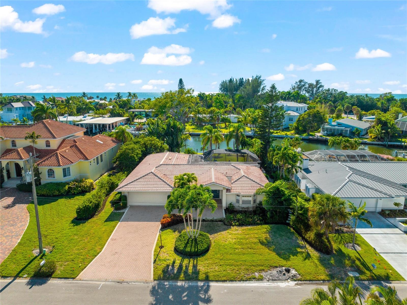 PRICE IMPROVEMENT!   Enjoy island living at its finest in the highly desirable Emerald Harbor community.  This home is built for relaxation and enjoying the Longboat Key lifestyle on a wide deep water canal with ideal boating and kayak access to Sarasota Bay with no bridges.  Take your bike or walk to the deeded beach access and experience sunset and swimming on one of the world-renowned beaches of the Gulf coast.   

Enter this fabulous 2600 sq. ft. 3 Bedroom, 2.5 Bath home and appreciate the seamless flow through the living room, dining room, family room, and kitchen area. Tile floors throughout the main living aeas are ideal for Florida living. This home has everything you need for entertainment plus everyday comfortable living.  The new, thoughtfully planned gourmet kitchen features custom cabinets, a center island with Walnut top, carefully selected quartz counters, all stainless Thermador appliances including double oven and cooktop, wine refrigerator and a pass-through to the lanai.  

The split floor plan provides privacy allowing homeowners to retreat to the spacious Master bedroom with walk-in closet and luxuries including a garden tub, separate shower, dual vanities, indoor and outdoor shower, and access to the pool area.    The guest bedrooms and bath are perfect for visiting family/friends or multi-generational living.

All main rooms leading to the pool area have hurricane/impact doors that pocket behind the wall for open indoor/outdoor living.   It doesn’t get any better than the incredible private and tranquil outdoor sitting areas with around the beautiful paver deck and pool area with new picture window screening.   Follow the paver pathway to an open fire pit and sitting area leading to the new composite dock w/10,000 lb. boat lift

The spacious laundry room is equipped with a second refrigerator, laundry sink, cabinets and incredible storage. It is rare to find a home with so much interior storage.

The premium mid-key location ensures that you are never far away from Longboat Key restaurants and shopping, plus the amenities of St. Armands, Sarasota and Anna Maria Island all the while relishing your peaceful seclusion, in tune to all the surrounding natural beauty Emerald Harbor has to offer.