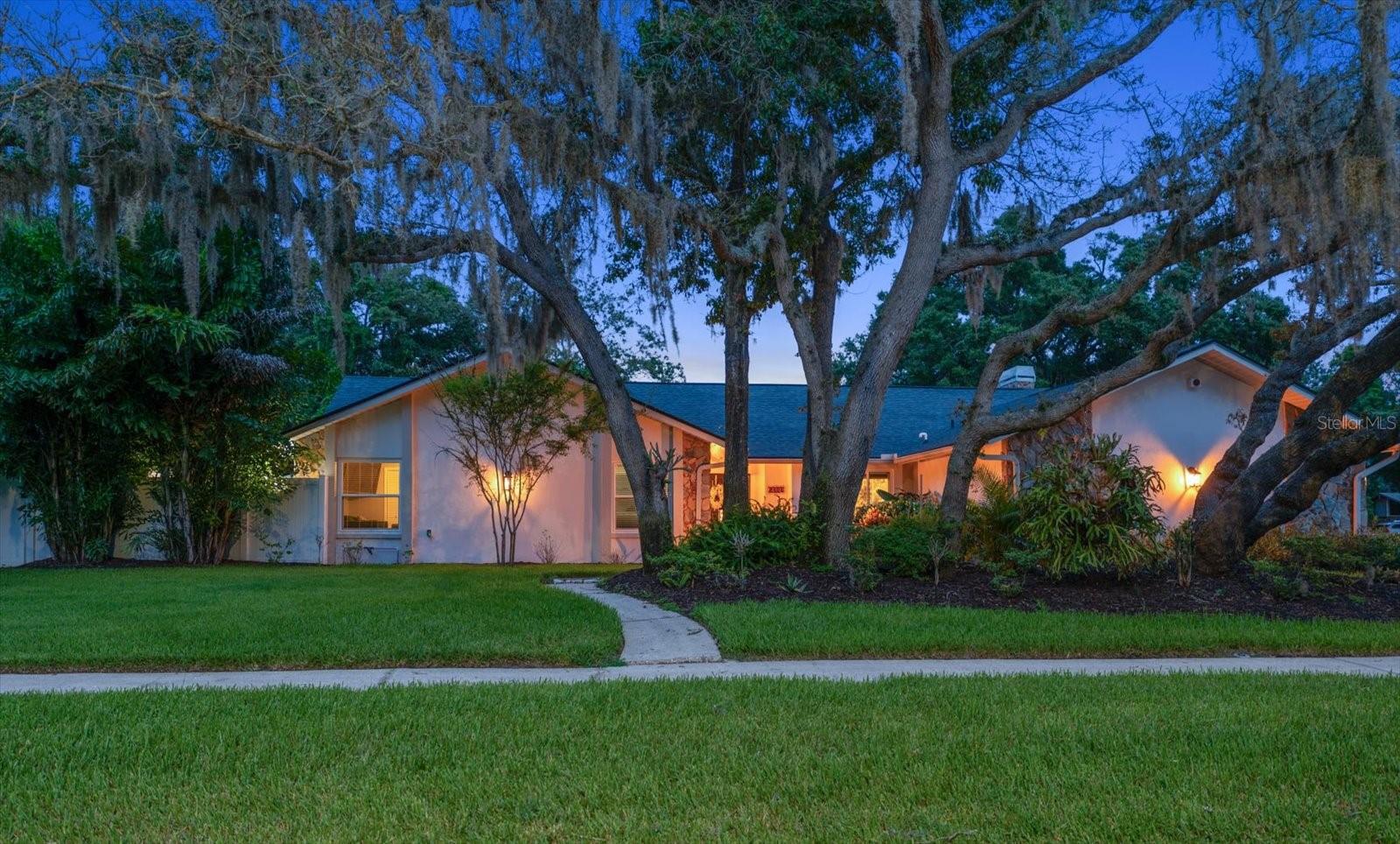 Virtually Staged. Welcome to this exceptional 4-bedroom, 3-bath residence with den/office/private entrance offering 3,399 square feet of thoughtfully designed living space on an oversized ½-acre lot in one of Clearwater's most desirable neighborhoods. Blending luxury upgrades, flexible living spaces, and an extraordinary backyard retreat, this home offers an exceptional Florida lifestyle.
Designed for both everyday living and effortless entertaining, the spacious floor plan is filled with natural light and enhanced by high-impact, energy-efficient windows installed in 2020, providing peace of mind, improved comfort, and long-term energy savings. A dual-zone HVAC system with two separate air conditioning units delivers efficient climate control throughout the home.  At the heart of the residence is a spectacular chef's kitchen, completely remodeled in 2023 with premium custom cabinetry, luxury finishes, and high-end appliances. Natural gas powers the range, tankless water heater, and dryer, offering the performance and efficiency today's homeowners appreciate.  One of the home's most distinctive features is the additional study/den with a private exterior entrance, creating the perfect space for a home office, remote work, client meetings, or homeschooling. This flexible room offers exceptional versatility while maintaining separation from the main living areas.  The primary suite provides a peaceful retreat, while three additional bedrooms and beautifully appointed bathrooms with ample space for family and guests.
Step outside to your own private resort featuring an extraordinary 50,000-gallon, 67-foot by 25-foot custom lap pool—a truly rare amenity seldom found in residential properties. Whether you're swimming laps, hosting gatherings, or simply relaxing poolside, this incredible outdoor space is designed to impress. Beyond the pool, the expansive half-acre homesite offers endless opportunities to enjoy the outdoors. Raised garden beds and a versatile garden shed/coop provide space for gardening, storage, hobbies, or even small-scale homesteading, while the sprawling yard leaves plenty of room for recreation, pets, or future additions. Ideally located just minutes from Clearwater's world-famous Gulf beaches, Tampa Airport, Safety Harbor, championship golf courses, shopping, dining, parks, and major commuter routes, this exceptional property combines luxury, functionality, and an unbeatable location.  This is a rare opportunity to own a truly distinctive home that offers comfort, flexibility, and resort-style living.