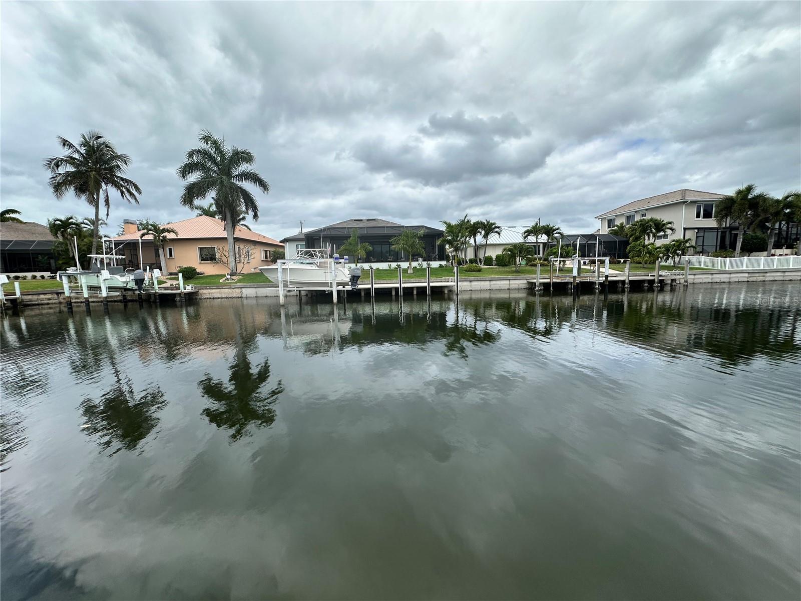 Calling all Boaters! Experience the ultimate Florida lifestyle on this stunning waterfront homesite in Punta Gorda Isles with fast sailboat or powerboat access! Boasting 80' of water frontage, this lot provides ample space for a large dock and a custom luxury pool home. Located on a wide, deep-water canal, you are just a short boat ride away from the open waters of the Gulf. This community offers a unique blend of elegance and leisure, with miles of walking paths, proximity to downtown Punta Gorda’s historic district, and sunset views that never get old. All city utilities are available at the site. City-maintained seawall included!
