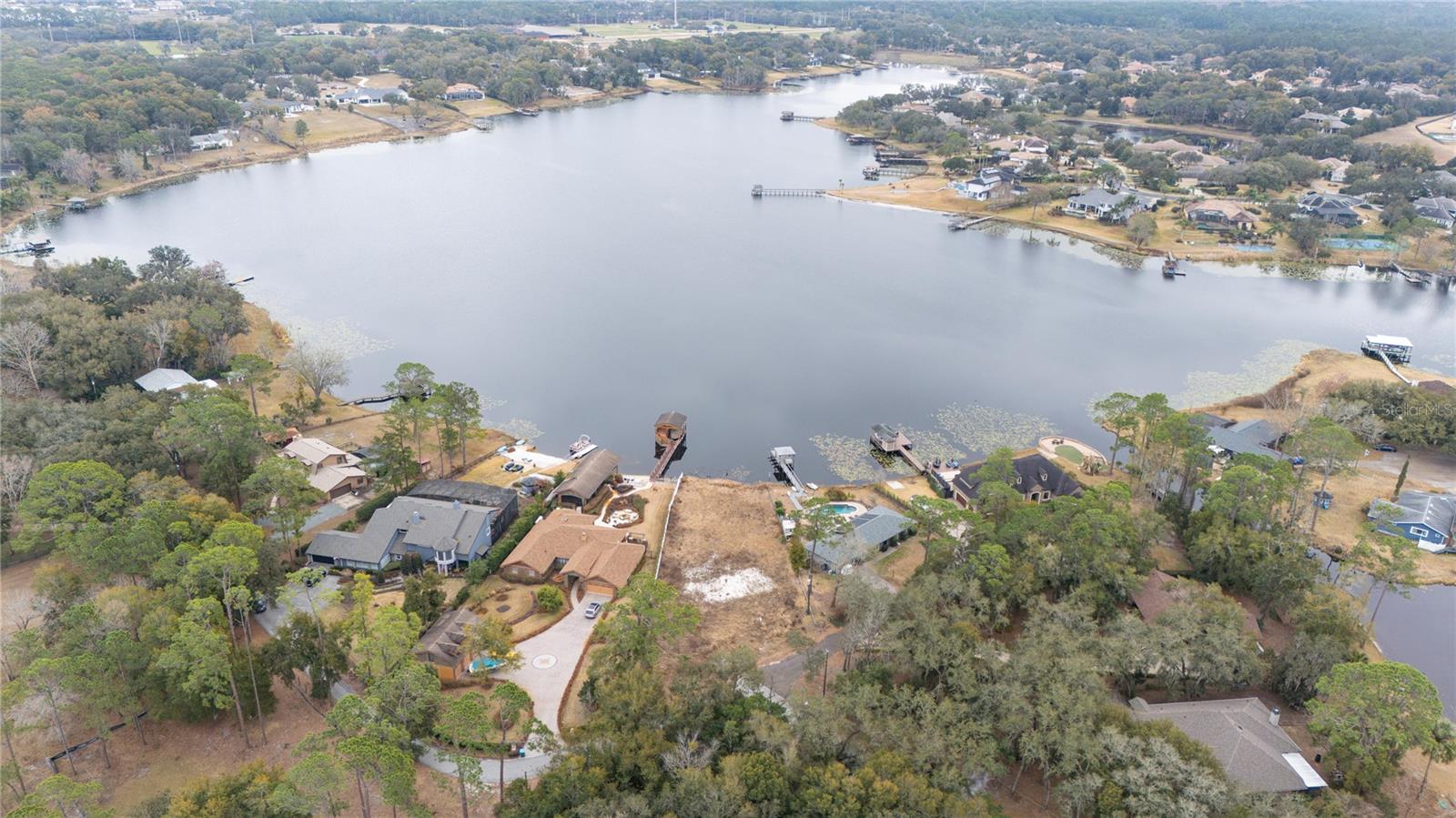 Life. Life. Lakefront. Explore the opportunity to build your lakefront dream home on sought-after Lake Markham, a chain of four bodies of water that are home to multi-million dollar estates. This .64-acre lot offers nearly eighty feet of shoreline with exceptional riparian depth, granting the new owner rights to build a dock or boathouse. The seller has build-ready plans available. With no HOA restrictions, the freedom to create a legacy estate is without limitation. Ideally near boutique shopping, fine dining, championship golf, private clubs, premier medical facilities and miles of picturesque trails, this remarkable offering pairs tranquil lakefront seclusion with everyday convenience.