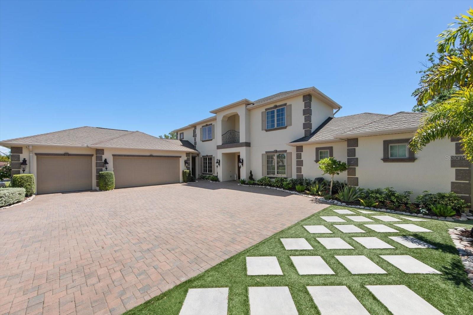 Under contract-accepting backup offers. Tucked on a quiet street right across from Belleair Country Club, this exceptional all-block residence delivers the rare combination of thoughtful architecture and extensive upgrades completed within the last year. From the moment you arrive, the professionally re-imagined landscaping, gemstone track lighting, designer lanterns, and resealed paver driveway set an immediate tone of refined curb appeal.
The floor plan is simply incredible. The primary suite is privately situated on the main level and features new chevron-pattern floors, two custom walk-in closets, and a huge luxury bathroom that rivals the finest resorts. From the main living area, oversized sliding glass doors open directly to the pool, creating a seamless indoor-outdoor flow perfect for entertaining or simply soaking in the Florida lifestyle.
The gourmet kitchen is a true showpiece — outfitted for the discerning chef and anchored by a beautifully designed new pantry that keeps everything organized and within reach. All guest bedrooms are thoughtfully positioned upstairs, offering privacy for owners and guests alike. Every interior wall has been insulated for exceptional quiet and energy efficiency, new flooring carries throughout the home office, and Pella windows frame every room with light and confidence.
The home's systems have been thoroughly modernized: two tankless water heaters, a commercial-grade whole-home generator, three new A/C systems — including a dedicated unit for the three-car garage — and an updated elevator all ensure the home runs as flawlessly as it looks.
Step outside to a backyard built for Florida living: new artificial turf, a sparkling pool with fresh equipment and new lighting, new outdoor fans, decorative rock landscaping along the side of the home, and a full perimeter security system for total peace of mind. The roof is top-of-the-line screwed construction — built to last and engineered for the elements. Homes of this caliber — completely move-in ready, on a serene street in one of Pinellas County's most coveted communities — rarely come to market. Schedule your private showing today.