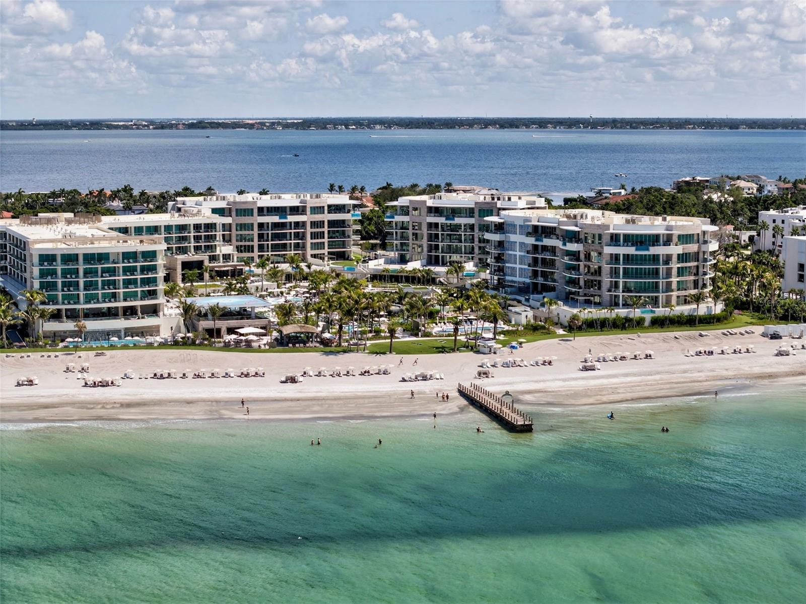 Experience spectacular Gulf of Mexico vistas from this direct west-facing and exceptionally private residence at The St. Regis Longboat Key. Floor-to-ceiling windows bathe the interiors in natural light and frame unobstructed water views, while the expansive living room provides the perfect setting for elegant entertaining. Step onto the sweeping 878-square-foot terrace—complete with a Wolf gas grill—and enjoy front-row seats to Longboat Key’s world-famous sunsets. The chef’s kitchen is a masterwork of form and function, featuring Poggenpohl cabinetry, Sub-Zero refrigeration, Wolf appliances including double ovens and a gas cooktop, microwave, dishwasher, and a wine/beverage refrigerator. The owner’s suite is a serene retreat with an entire wall of glass overlooking the Gulf and resort grounds. A custom Closet Envy wardrobe ensures abundant storage, while the spa-like bath offers dual vanities, a soaking tub, walk-in shower, and Toto electric commode. The generous ensuite guest bedroom also enjoys Gulf views, custom built-ins, and direct access to the terrace. Finishes throughout, curated by Marc-Michaels Interior Design, embody timeless sophistication. Beyond the residence, The St. Regis Longboat Key offers a collection of world-class amenities designed exclusively for its residents. The private clubhouse features a state-of-the-art fitness center and a resident-only pool and spa. Signature St. Regis Butler and Concierge services set a new standard for luxury living. Indulge in the oceanfront spa, diverse dining venues, and beachfront cabanas, or enjoy family-friendly amenities including a lazy river and a saltwater lagoon teeming with tropical fish, stingrays, and the resort’s resident tortoises. Set on 17 acres of pristine beachfront, and just 3.5 miles from St. Armands Circle’s renowned shopping and dining, this residence represents more than a home—it’s an invitation to embrace the legendary St. Regis lifestyle, where elegance, comfort, and unparalleled service define every moment. Begin your journey to Live Exquisite at The St. Regis Longboat Key