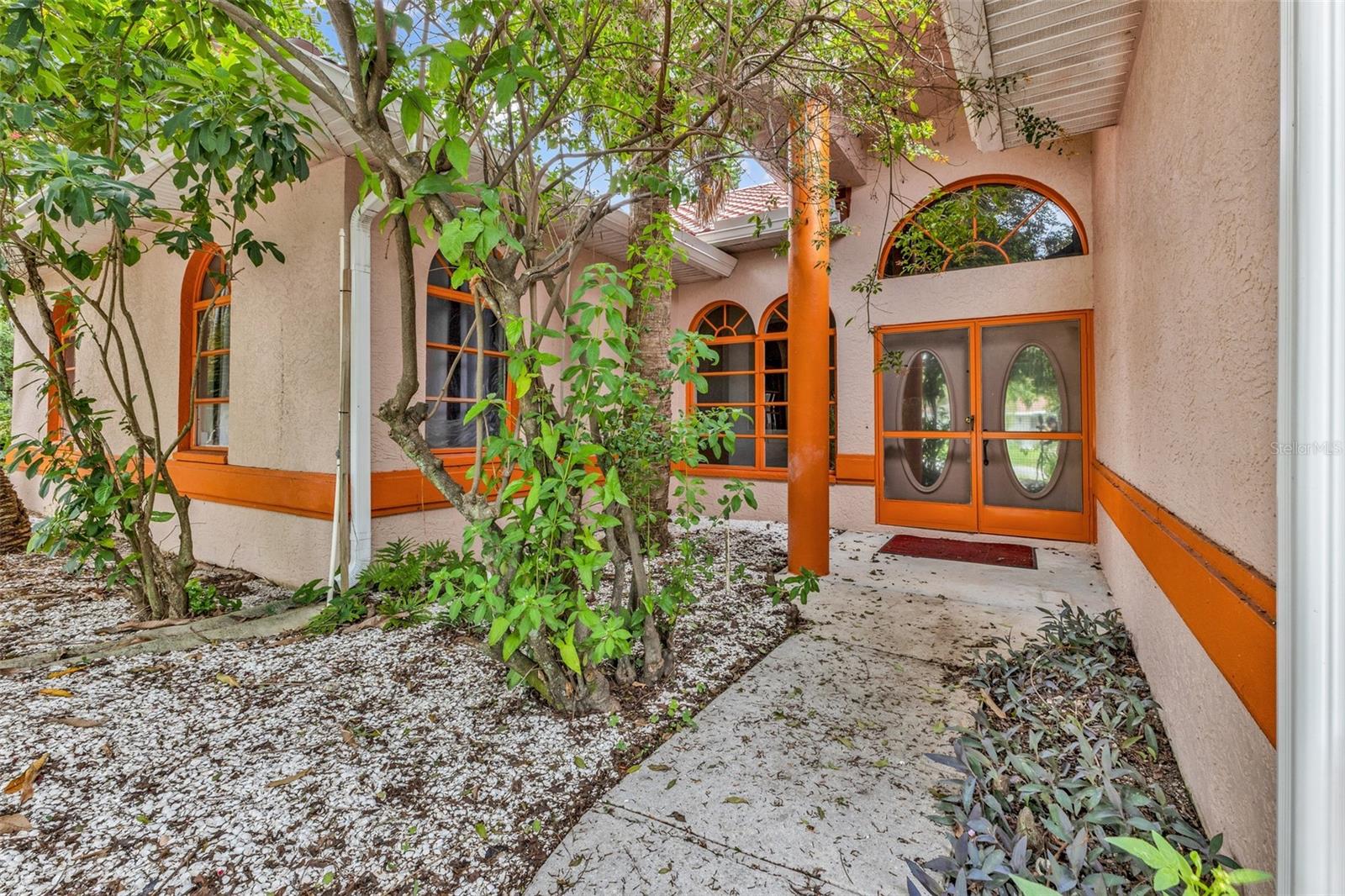 MORNING COFFEE IN THE SUNROOM. EVENINGS SURROUNDED BY TROPICAL GREENERY. A HOME WITH ROOM TO GROW.

Tucked away on a rare double lot in the heart of Port Charlotte, this unique 4BR + Den, 3BA home offers over 4,000 square feet of functional interior living space, including a permitted 675-square-foot enclosed sunroom that was formerly a screened lanai. The result is an expansive floor plan with flexibility for multigenerational living, extended stays, hobbies, entertaining, or simply spreading out and enjoying life.

Significant recent improvements have already been completed, including a 2025 metal roof, 2025 HVAC system, 2025 whole-house repipe, and a permitted enclosed sunroom conversion that transformed the former screened lanai into valuable additional living space (per seller and permits), allowing the next owner to focus less on major projects and more on enjoying their new home. Distinctive architectural details, soaring ceilings, arched windows, and custom design elements create a home unlike today’s typical cookie-cutter floor plans. Inside, you’ll find generously sized living areas, two primary suites, abundant natural light, and a layout designed for comfortable everyday living. Whether accommodating extended family, guests, hobbies, a home office, or simply a desire for more room to spread out, the flexible floor plan offers options rarely found at this price point.

Step outside and you’ll discover what was once envisioned as a tropical garden retreat. Mature landscaping, winding pathways, trellises, garden structures, and multiple outdoor gathering spaces create a setting unlike the typical Florida backyard. While portions of the landscape would benefit from TLC and restoration, the framework for an extraordinary outdoor oasis is already in place. Whether you dream of restoring the original vision, creating a gardener’s paradise, or designing your own personal sanctuary, the possibilities are truly endless.

Conveniently located near Charlotte Beach Park, public boat ramps, waterfront parks, fishing, dining, shopping, medical facilities, Sunseeker Resort, and the vibrant Punta Gorda area, you’ll enjoy easy access to the Southwest Florida lifestyle so many dream about. Spend the day exploring Charlotte Harbor, enjoy waterfront dining at sunset, or simply come home and relax beneath the shade of mature palms in your own slice of Southwest Florida paradise.

With over 4,000 square feet of functional interior space, two primary suites, major recent system updates, and a rare double-lot setting, this is more than just a home—it’s an opportunity to create something truly special.