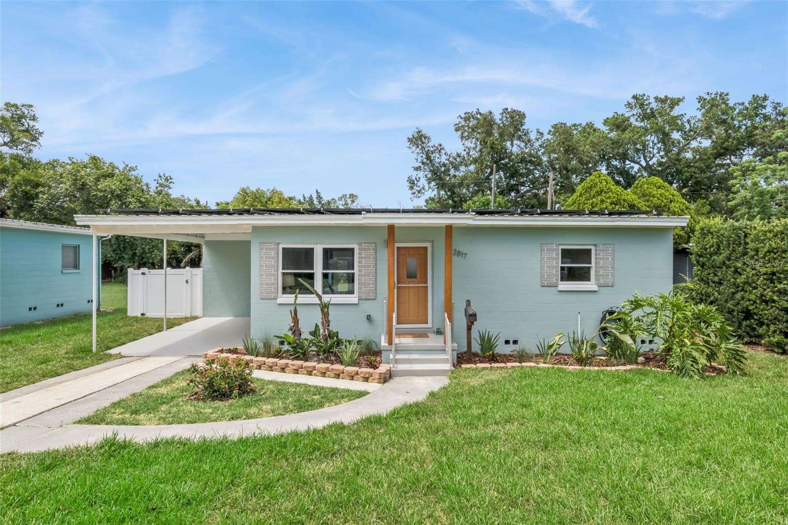 Welcome home to this beautifully updated concrete block home blending timeless mid-century charm with extensive modern upgrades and impressive energy-efficient features. Thoughtfully remodeled, this move-in-ready property offers restored original hardwood floors, vaulted ceilings, a light-filled sunroom, fresh landscaping, sustainability and an open-concept layout. 

The expanded kitchen, remodeled in 2015, is in the heart of the home and features premium one of a kind granite countertops, 42” shaker-style cabinetry with soft-close hinges, multiple drawer base cabinets, plywood box construction, a center island with bar seating and a functional pass-through overlooking the sunroom and back garden — perfect for entertaining and everyday living. 

One of the home’s standout features is the incredible sunroom surrounded by double-pane windows and overlooking the freshly landscaped backyard. Complete with built-in booth seating, this flexible space is ideal for dining, game nights, entertaining, or a home office setup. Additional highlights include an indoor laundry room under air, offering everyday convenience rarely found in many homes of this era.

Major updates include a metal roof installed in 2017 with insulated roof decking panels, added ceiling insulation, HVAC system replaced in 2021, all-new ductwork in 2026, both bathrooms remodeled in 2026, re-plumbed supply lines in 2015, upgraded electrical service in 2024, energy-efficient Low-E argon gas-filled windows installed in 2015, fresh interior and exterior paint, vinyl fencing, irrigation system, and fresh landscaping. 

The fully owned 12.40 KWp whole house solar system installed in 2019 provides exceptional energy efficiency and also includes dedicated daytime backup power outlets for essential items during outages. 

Step outside to enjoy the spacious backyard (big enough for a pool), expansive paver patio, detached storage shed, and attached bonus workshop/flex space offering endless possibilities for storage, hobbies, fitness, studio space, or a home office. 

Ideally located in the Lake Como community between the Milk District and the Curry Ford West/Hourglass District, this home offers convenient access to some of Orlando’s best local dining, coffee shops, breweries, entertainment, and shopping destinations. Downtown Orlando, the Dr. Phillips Center for the Performing Arts, Inter&Co (Soccer) Stadium, and the Kia Center are all located just a few miles away, making this location ideal for enjoying everything in Orlando’s vibrant urban core.