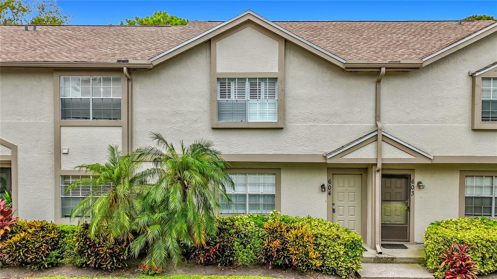 Nestled in the popular bayside community of Eastwood Shores, this tastefully updated condo offers a blend of comfort and modern style. The interior showcases thoughtfully upgraded features including a renovated eat-in kitchen with sleek tile backsplash, contemporary cabinetry and stainless steel appliances. An inviting lanai provides a serene retreat to enjoy morning coffee or unwind after a busy day. It also has a storage closet. Upstairs features the primary suite with vaulted ceilings, large closet and updated ensuite bath including glass enclosed step in tiled shower with storage niches, vessel sink and granite counters. Two more bedrooms plus updated guest bathroom round out the upstairs. The living room and all bedrooms feature custom plantation shutters. The roof was replaced in 2024. For added convenience, this townhome includes a dedicated carport space just steps from the front door. HOA fee includes water, sewer, cable, internet, building insurance, trash, grounds and exterior building maintenance. Eastwood Shores residents enjoy amenities including pool, tennis and boardwalk trail to the community bayside dock, all just steps away. This convenient location is in close proximity to local favorites including shops, restaurants, entertainment, golf courses, parks, two international airports and award winning Gulf beaches. Plus, it is just 20 minutes to the charming cities of Dunedin and Safety Harbor or 30 minutes to the vibrant cities of St. Pete and Tampa. Take advantage of this great value and enjoy the sunny Florida lifestyle today!