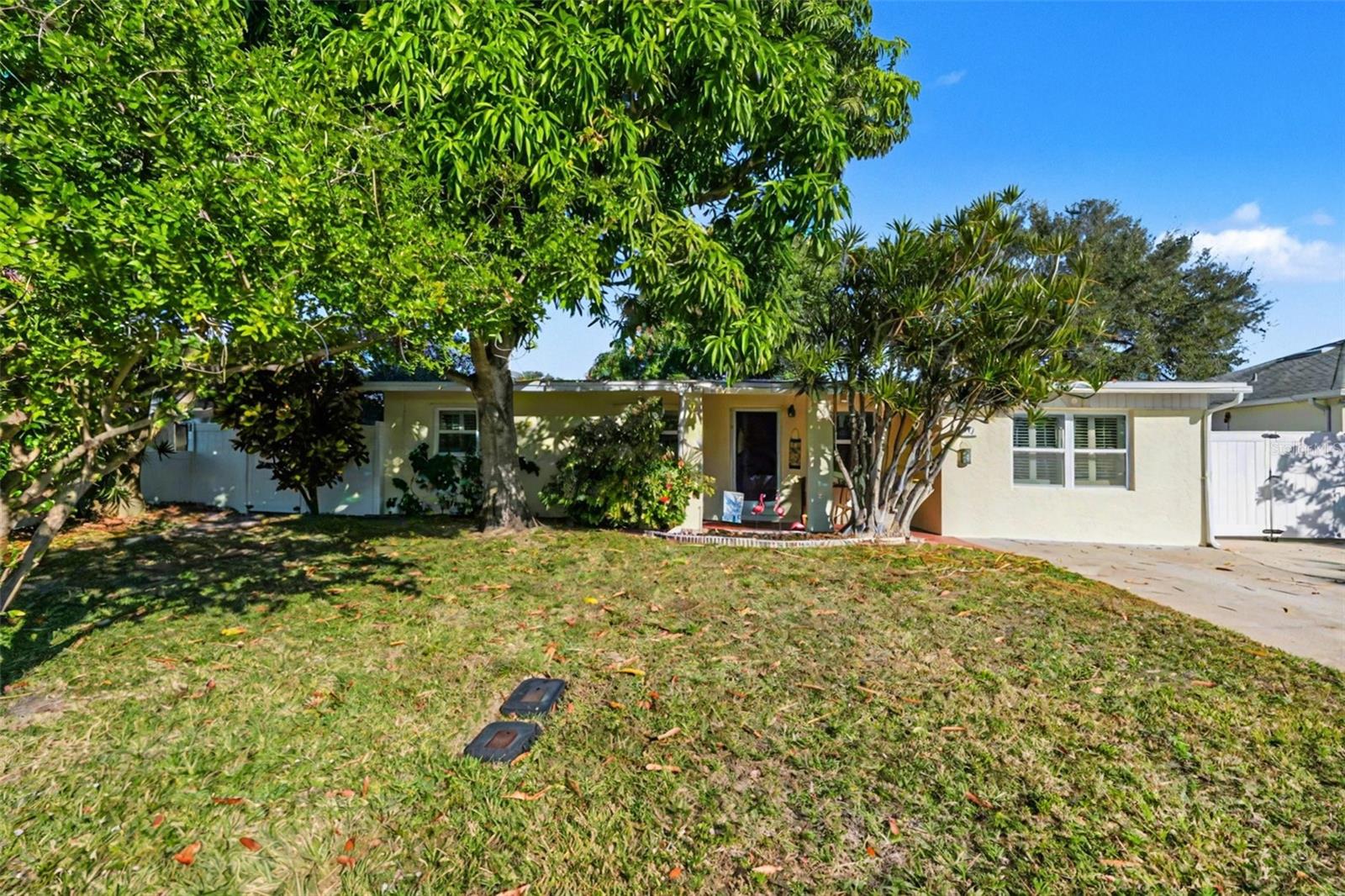 Weekly rentals are permitted—making this an exceptional beachside retreat or investment opportunity. Just steps from the sand with beach access at the end of the street, this fully updated 4-bedroom, 2-bath Cape Canaveral home offers the best of coastal living with modern upgrades throughout. The full kitchen was remodeled one year ago with new cabinets, countertops, appliances, an induction range with air-fryer mode, and new flooring. Hurricane-impact windows and plantation shutters provide style and peace of mind, while the roof is approximately 6 years old. The primary suite was beautifully remodeled two years ago. Outdoor living shines with two new patios, outdoor shower, an arbor, updated vinyl fencing, and two sheds. The lush yard features fruit trees including fig, black sapote, banana, papaya, orange, cherry, and mango.