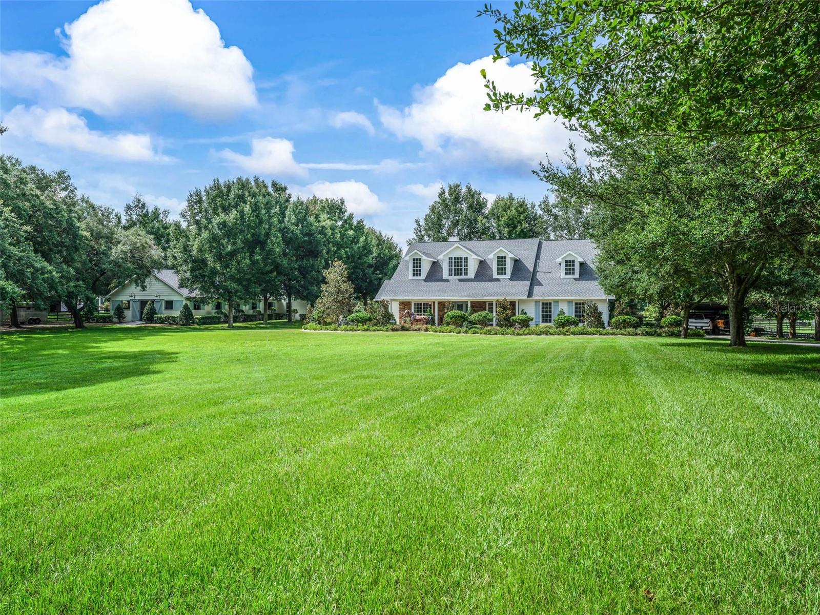 Very Special 10 acre farm within golf cart distance to WEC! Beautiful 3000+sf, 4 bedroom, 3 bathroom custom home with exceptional outdoor living space, summer kitchen and wood fire pizza oven. 10 stall center aisle show barn complete with 2 indoor grooming/wash bays, tack room, laundry, full bathroom, lounge, feed room, 24 hr camera surveillance system that can be viewed from your phone, fans, fly spray system, and huge garage for equipment storage. The farm facilities are truly set up for the professional equestrian with: 6 horse eurowalker with GGT footing, 6 lush paddocks with beautiful shady oak trees, a huge irrigated turf riding field, New GGT footing jump arena w/full show jumping course, New GGT footing round pen, Two automatic gated entrances, Trailer parking area, RV hookup, Shavings storage and manure bin area, etc. Don’t miss this spectacular turn key farm!