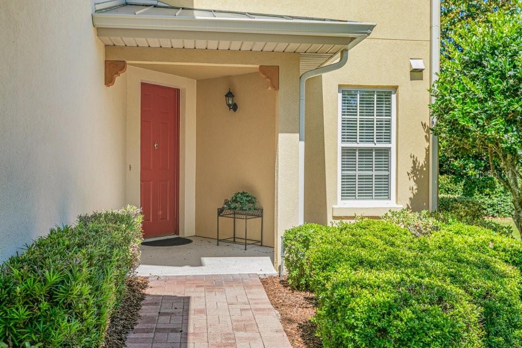 Move-in ready and beautifully maintained, this spacious ground-floor END UNIT condo offers over 1,500 square feet of comfortable living with NO stairs! Tucked away at the end of a quiet, small community, this home provides both privacy and convenience. Enjoy the ease of a private 1-car garage, abundant storage space, and luxury vinyl flooring throughout the main living areas. The kitchen features gorgeous granite countertops and plenty of room for entertaining. Relax year-round on the covered and screened back porch overlooking the peaceful lake — the perfect spot to enjoy stunning sunrises. Located just steps from the pool and mailbox, it truly feels like having your own private resort! Conveniently close to shopping, dining, and only a short drive to the beach, this condo offers the ideal blend of comfort, location, and low-maintenance living.