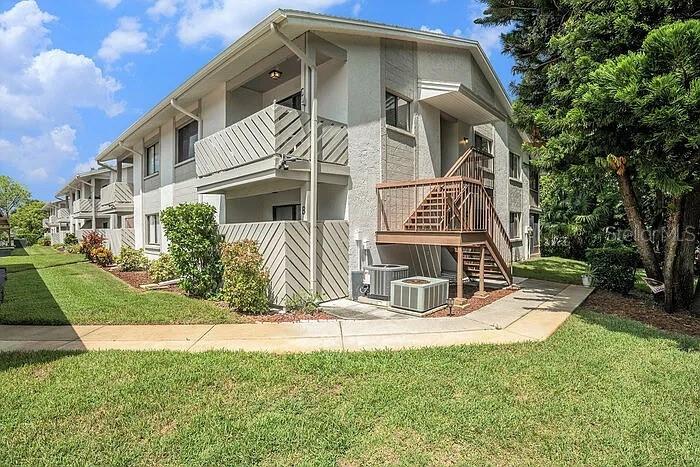 Say hello to your turnkey, low-maintenance Florida retreat in the Eagleswood community at Beacon Woods! This light and bright corner-unit, 2 bedroom, 2 bath condo features 1,144 sqft. of living space that is thoughtfully laid out and filled with natural light. This condo has been tastefully updated with luxury vinyl flooring, neutral paint and crown molding throughout, giving it a clean, polished feel. New AC and hot water heater in 2025. The kitchen has also been updated with stainless steel appliances, including a newer refrigerator, disposal, microwave and dishwasher. Enjoy in-unit laundry as there is a laundry closet in the kitchen with full-sized, side-by-side washer and dryer. 

TWO patios flank either end of the condo and are a valuable extension of the main living spaces — one is located just off of the kitchen (perfect for alfresco dining!), and the other is in back off of the living room - perfect for quiet morning coffee and unwinding in the evenings. The screened-in rear patio overlooks lush mature trees for total peace and privacy.

The main living space spilts both bedrooms. The updated bathrooms have newer vanities with granite countertops.  The primary en-suite bath features a walk-in shower with tiled walls and stone flooring. While the second bathroom has a tub/shower combo - perfect for little ones or pet bath time!

The REASONABLE HOA FEE of $465/ month covers cable TV, internet, water, sewer, trash, building and grounds maintenance, insurance, reserves, community pool, and common area taxes — everything except electric! This established community is well kept and offers the ideal low-maintenance lifestyle for snowbirds and full-time residents alike, with a heated pool and spa, clubhouse, tennis/pickleball, and easy golf access. You’re minutes from Hudson Beach and the Gulf, plus local restaurants with live music.
Condo comes with one assigned parking space and ground-level storage. Small pets under 25 pounds are welcome. True affordable, easy living! Note: Pictures feature furniture from previous staging.