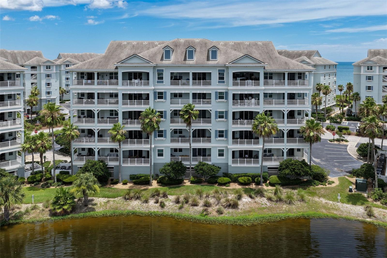 Enjoy the best of coastal resort living in this beautifully updated second-floor condominium located within the highly sought-after gated community of Cinnamon Beach at Ocean Hammock. Overlooking a tranquil lake with glimpses of the Atlantic Ocean beyond, this spacious residence offers the perfect blend of comfort, style, and investment potential.

The open-concept floor plan features luxury vinyl plank flooring throughout the main living areas, crown molding, and abundant natural light. The renovated kitchen is designed for both functionality and entertaining, showcasing cabinetry, quartz countertops, stainless steel appliances, a large breakfast bar, and a coastal-inspired tile backsplash. The kitchen flows seamlessly into the dining and living areas, creating an inviting space for gathering with family and friends.

Sliding glass doors open to a generous covered balcony overlooking the lake, providing the ideal setting to enjoy morning coffee, evening breezes, and picturesque water views. The spacious living room is thoughtfully designed with comfortable seating and coastal finishes, while the dining area offers ample room for entertaining.

Located just steps from the beach, this residence provides easy access to Cinnamon Beach's exceptional amenities, including oceanfront and lakeside pools, a fitness center, game room, seasonal café, clubhouse, and private beach access. Whether you're seeking a primary residence, vacation retreat, or income-producing rental property, this turnkey condominium offers an outstanding opportunity to enjoy the Florida coastal lifestyle.

Community Features: Gated Oceanfront Community • Beach Access • Oceanfront & Lakeside Pools • Fitness Center • Clubhouse • Seasonal Café • Game Room • Walking Trails • Short-Term Rentals Permitted.