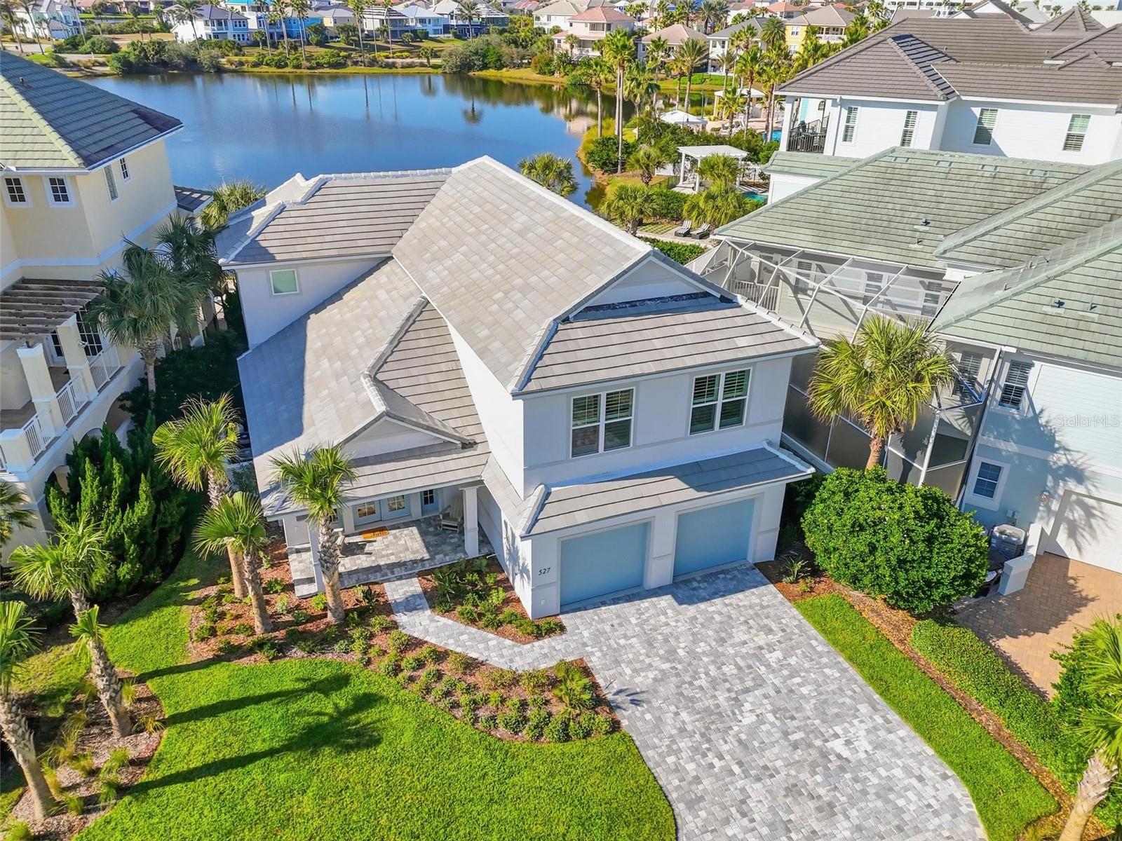 Brand new custom built home with high-end furnishings being offered turn key as luxury vacation rental; get ready to embrace coastal living in this breathtaking masterpiece nestled in the exclusive Cinnamon Beach Community of Ocean Hammock, Palm Coast, Florida. This remarkable oceanfront neighborhood is a hidden gem, offering an array of luxurious amenities including an oceanfront pool, serene lakefront pool, a well equipped gym, inviting clubhouse, and a grill for those delightful outdoor meals. Whether you're seeking a savvy investment, a second getaway, or your forever home, this property accommodates all desires with its allowance for short-term and nightly rentals. Step inside this exquisite residence featuring five spacious bedrooms and four and a half elegantly designed bathrooms. Built with solid construction standards, the first floor boasts reinforced block, complemented by storm impact doors and windows for peace of mind. Enjoy the elegance of eight-foot solid core interior doors, a durable concrete tile roof, and a high-efficiency 15 Seer HVAC system.  The outdoor oasis features a stunning custom saltwater heated pool and spa that overlooks a picturesque lake, complete with a summer kitchen and beautiful paver details surrounding the pool and patio area—perfect for entertaining or relaxing in the sun. Inside, no detail has been overlooked. Revel in the luxury of Hawikuh quartz vinyl flooring, custom solid wood kitchen cabinets with dovetail joints and soft-close drawers, and luxurious quartz countertops throughout. The master suite boasts California closets, while the home is adorned with exquisite hardware, lighting, and top-of-the-line appliances. Situated conveniently near shopping and dining, you’re just 30 minutes from the historic charm of downtown St. Augustine, 15 minutes from the vibrant atmosphere of Flagler Beach, and a short drive to Daytona Beach.
