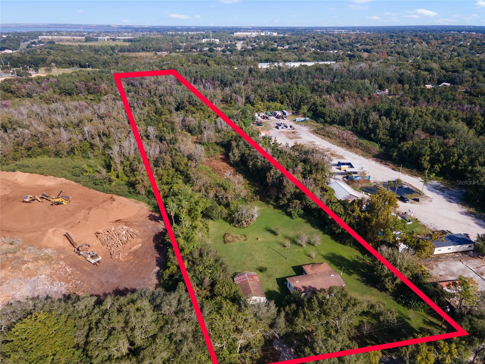 4.5 acres in Ocoee, FL close to everything! This parcel is nestled down a dirt road and offers a haven of privacy. Surrounding properties host commercial uses, opening the door to various commercial possibilities; however, it's advisable to consult with the City of Ocoee to ensure compatibility with your intended use as this property is currently zoned R-1.  

While a significant portion of the property is designated as flood zone AE, the city proactively addressed drainage concerns by digging a ditch along the western edge of the property a few years ago. This ensures that the property drains quickly and has efficient water management.

The existing structure is likely a tear down, but the true value lies in the expansive 4.5 acres of land. This presents an exciting opportunity for those envisioning a large food forest or wanting to utilize the space for large format storage needs.

Whether you're dreaming of a commercial venture or a unique agricultural project, this acreage offers a canvas for your ideas. Embrace the potential, explore the options, and envision the possibilities that this sprawling 4.5-acre property has to offer.