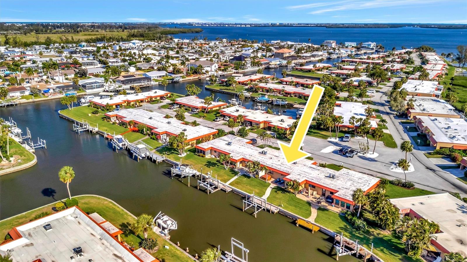 Welcome to your waterfront retreat in Palma Sola Harbour, a highly sought-after gated boating community located less than 3 miles to the gulf beaches! This beautifully updated 2-bedroom, 2-bath canal-front condo offers 1,296 square feet of stylish living space and the perfect combination of comfort, design, and true Florida coastal living. Step outside to your paver brick patio overlooking the canal—an ideal spot for relaxing or entertaining. Enjoy direct boating access from your private dock, complete with a 9,000 pound, lift featuring remote control operation. Unwind in the nearly new hot tub (just one year old) while taking in the peaceful waterfront setting. Inside, the home has been completely updated and features a bright, open floor plan filled with natural light. The expanded gourmet kitchen is a standout, offering abundant storage, modern finishes, and plenty of space for cooking and entertaining. Tile flooring flows throughout for a seamless look, and both bathrooms have been tastefully updated. Offered furnished, this move-in ready home is ready for immediate enjoyment—ideal as a full-time Florida home or seasonal escape. Palma Sola Harbour features resort-style amenities including two heated pools, tennis and pickleball courts, a fitness center, dry saunas, a workshop, putting green, and a billiards room. Large pets are allowed and there are no age restrictions.