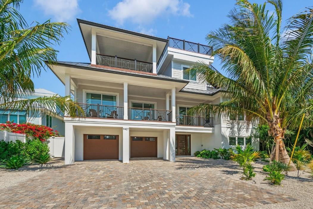 Located on picturesque Anna Maria Island, this exceptional 9-bedroom, 8.5-bathroom coastal retreat offers 4,244 sq ft of heated living space with luxurious amenities throughout. The open-concept interior features an oversized kitchen with a spacious quartz island, upgraded appliances, and a wet bar for entertaining. Enjoy the multiple balconies or the rooftop deck, showcasing Gulf of Mexico views and unforgettable sunsets. Just a 3 MINUTE WALK TO THE BEACH! The private backyard oasis includes a custom styled pool with a hot tub, a game area, and plenty of space for lounging. The primary suite, located on the third floor, includes a king bed, private balcony, and a spa-like ensuite with an enclosed shower and tub. 5 additional king bedrooms feature ensuite bathrooms, some with balcony access, while 2 king bedrooms share a hallway bathroom. The ninth bedroom offers a full-over-full bunk bed and an ensuite bath. ALL FURNISHINGS INCLUDED. Additional highlights include an elevator, game room, and parking for up to FIVE cars. This ideal beach retreat combines modern elegance with relaxed island charm- GREAT RENTAL OPPORTUNITY.