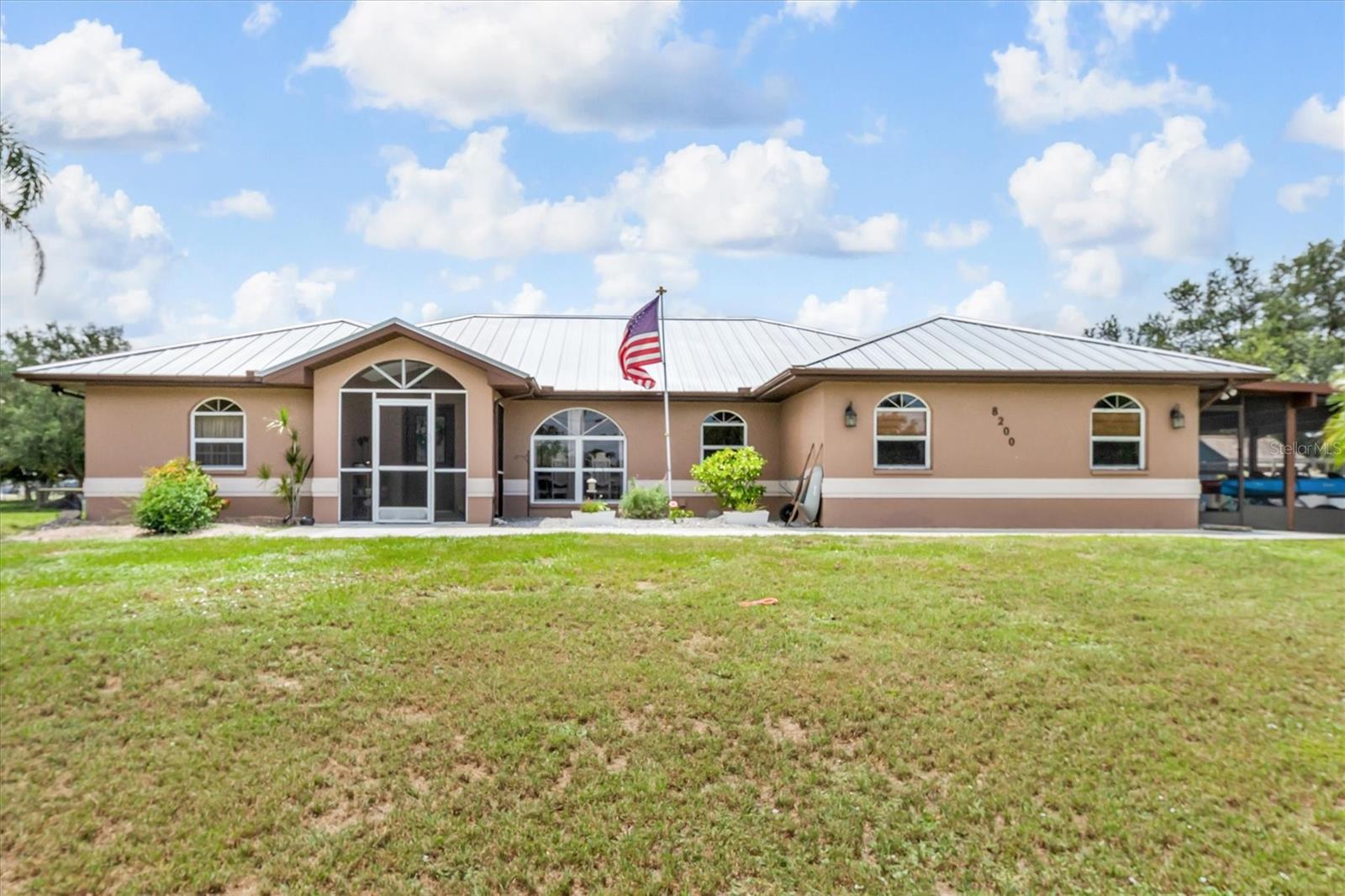 Two homes. 4.5 fully fenced acres. A saltwater pool, four-car garage, solar power, and a ready-to-use homestead setup—all in Punta Gorda. This unique property delivers the space, flexibility, and privacy buyers are searching for, while keeping downtown, I-75, Charlotte Harbor, and the Peace River within easy reach.

PROPERTY HIGHLIGHTS:

• 4.5 fully fenced acres with gated entrance
• Two separate residences totaling approximately 3,430 square feet
• Main home: 2,198 square feet, three bedrooms, two bathrooms, plus bonus room
• Second home: approximately 1,232 square feet, two bedrooms and one bathroom
• Detached four-car garage and large covered carport
• Newer standing-seam metal roofs on all buildings
• Solar power serving both homes
• Flood Zone X, where flood insurance is generally not required by lenders
• New 2026 air-conditioning system and air handler in the main home
• Saltwater pool with newer pump and heat pump
• More than $190,000 in improvements completed within the past five years

The main residence features an open great-room design and a spacious kitchen with granite countertops, breakfast-bar seating, finished wood cabinetry, double sink, and an under-sink reverse-osmosis system. The owner’s suite includes dual sinks, a walk-in shower, and a separate soaking tub. Two additional bedrooms share a bathroom that also serves the pool area, while the bonus room provides space for an office, den, playroom, or game room. Interior laundry and a large covered carport add everyday convenience.

The screened lanai opens to a saltwater pool that has recently been drilled, releveled, sealed, and resurfaced. A newer pool pump and heat pump help extend the swimming season. The outdoor area also includes generous patio space and a 16-by-16-foot fire-pit area.

The independent second residence offers its own living room, dining area, kitchen, two bedrooms, one bathroom, enclosed front porch, and separate septic system. It is well suited for extended family, guests, a private office, or potential rental use, subject to applicable regulations.

Additional improvements include an updated well system, new well house, whole-home generator hookup, RV hookup, Eleos EMF boxes for surge protection and EMF reduction, fresh interior paint, new carpet, recessed lighting, updated electrical components, and a newer refrigerator.

The property is already equipped for animals and homestead living, with a 40-by-60-foot goat pen, an 8-by-8-by-12-foot chicken coop, an enclosed run, and a 30-by-35-foot outdoor run. The remaining acreage provides room for horses, gardens, recreational vehicles, equipment, and outdoor hobbies.

With two independent homes, 4.5 acres, extensive upgrades, solar power, a pool, substantial garage space, and an established animal setup, this Punta Gorda property offers a rare combination of versatility, self-reliance, and Southwest Florida living.

Sheds do not convey.