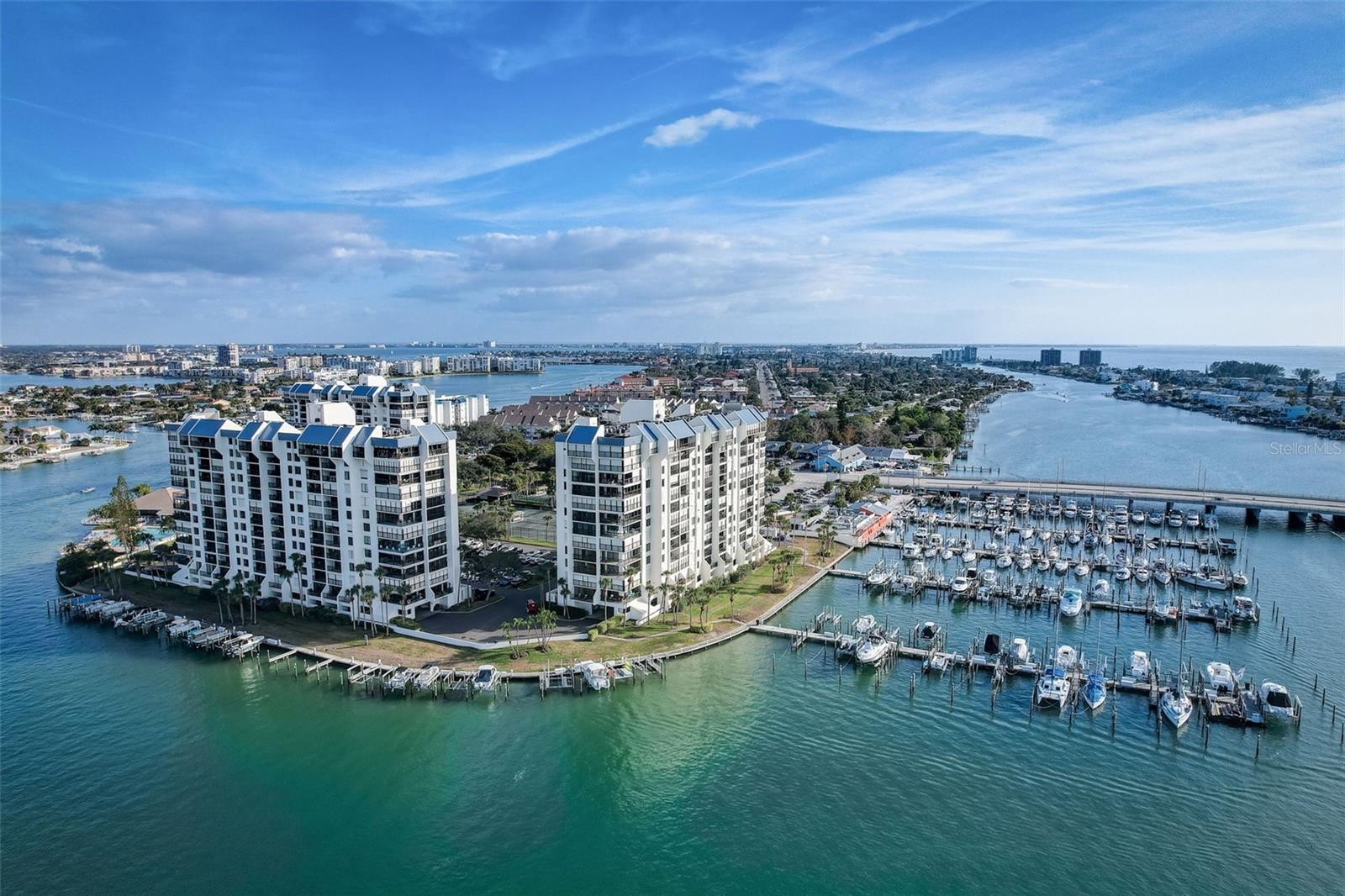 WATERFRONT 2/2 in luxury Yacht & Tennis Club of St Pete Beach.  This lovingly maintained 2-bedroom, 2-bath residence features a bright, open floor plan perfect for both relaxing and entertaining. The beautifully updated kitchen boasts a stylish island and contemporary finishes, seamlessly flowing into the living and dining areas. Admire the coastal-inspired quartz countertop and backsplash, that coordinates beautifully with the white raised panel cabinets.  There is even a cabinet to store your fishing poles!!  The spacious primary suite offers a private en suite bath with a sleek walk-in shower, while the versatile second bedroom includes a custom office setup with a convenient Murphy bed—an ideal room for guests or remote work. Step out onto your private balcony and take in breathtaking views, the perfect backdrop for morning coffee or evening sunsets. Located in a desirable high-rise within the Yacht and Tennis Club, this unit provides added security and peace of mind with hurricane shutters and an elevated position that enhances both natural light and panoramic scenery. A water heater replacement in 2026 adds extra value and reliability and the storm shutters add peace of mind. Please note this is a non-smoking building.  Enjoy resort-style living with exceptional amenities including a waterfront heated pool and spa, saunas, state-of-the-art fitness center, 7 HarTru tennis courts with two lined for pickleball, modern clubhouse, marina access with boat slips, and 24-hour manned gated security. Enjoy an active social life with lots of community activities, or enjoy a laid-back beach vibe with the pristine local beaches a short distance away.  Lush, well-maintained grounds and scenic walking paths and boardwalk complete the experience. All this just moments from top-rated restaurants, shopping, and the beautiful Gulf beaches—offering the ultimate blend of luxury, convenience, and the Florida coastal lifestyle.  Make your appointment today!