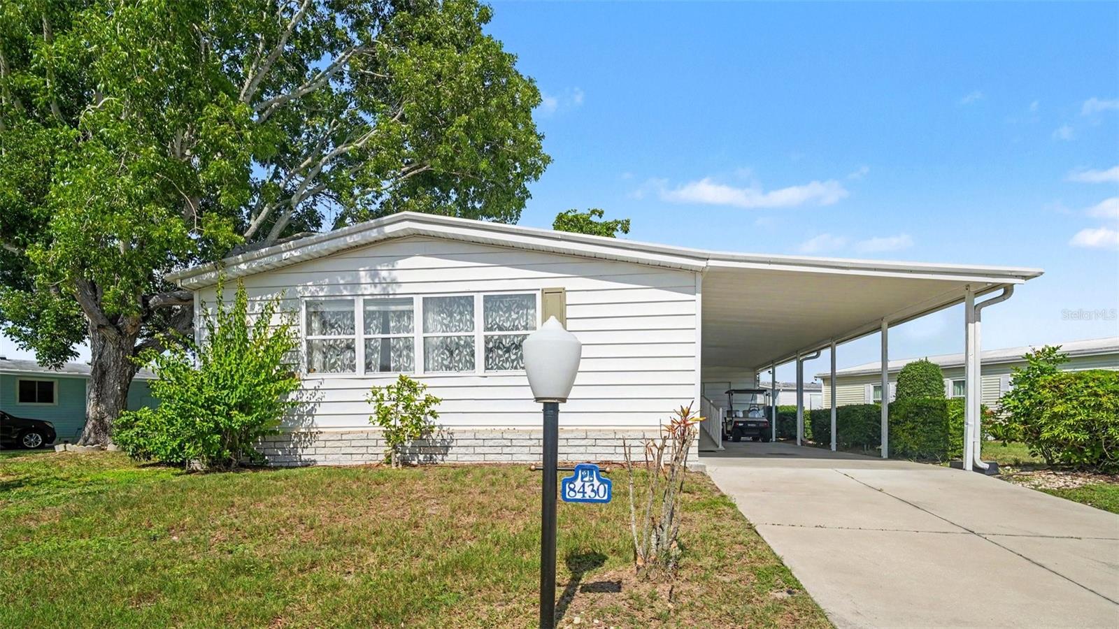 BEST PRICE IN THE COMMUNITY! Welcome to this beautifully maintained 2-bedroom, 2-bath home in the highly desirable Imperial Lakes Estates, a premier 55+ land-owned community.

This freshly painted, move-in-ready home is offered with the current furniture (if desired), making it perfect for year-round living or a seasonal retreat.

The spacious floor plan is filled with natural light and features a large living room with custom built-ins, a separate family room, a bar area that's perfect for entertaining, and a Florida sunroom, ideal for relaxing with a coffee or a book. 

The primary suite offers a walk-in closet and an en-suite bath with dual vanities and a recently renovated walk-in shower. The second bedroom includes a built-in desk and a generous closet. An oversized storage room provides endless possibilities for hobbies, a workshop, or additional storage. A newer A/C provides  peace of mind.

Additional features include a carport, a storage shed, and low quarterly fees that cover cable, internet, and community amenities.

Enjoy an active lifestyle with two heated pools, pickleball, tennis, shuffleboard, a clubhouse, and countless social activities, all centered around a scenic 65-acre spring-fed lake. Conveniently located near shopping, dining, golf courses, I-75, and just a short drive to Sarasota, St. Petersburg, and Tampa. The pet-friendly community allows up to two dogs (25 lbs. max each).