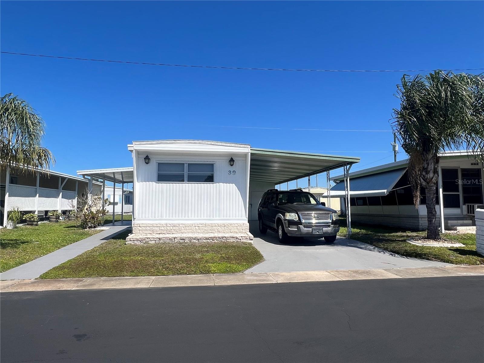 Welcome to Lake Highlander Mobile Home Park – A Highly Desirable 55+ Community in Dunedin!
This fully furnished and exceptionally clean home is truly move-in ready—just bring your personal belongings and start enjoying the Florida lifestyle.
Inside, you’ll find a well-maintained interior featuring new subflooring and beautiful luxury vinyl flooring throughout, along with 1 full bath plus a convenient half bath. The home comes completely equipped with everything you need, including a new refrigerator, glass-top stove, microwave, toaster, and dining set.
The spacious living area is comfortably furnished with a sofa, recliner, end table, floor lamp, and a new smart TV, complemented by window blinds and curtains throughout. Both bedrooms have queen-size beds with protected mattresses and box springs, built-in dressers, nightstands, and dual closets in each room—providing plenty of storage space. Additional storage includes a hall closet and pantry.
Step outside to enjoy even more extras:
• Utility shed with dryer and additional storage 
• Deep carport—perfect for larger vehicles and/or a golf cart 
• New front patio porch cover, ready to be screened in if desired 
• Patio furniture, bikes, fishing poles, tools, and ladder—all included 
This home has been meticulously cared for, featuring:
• Annual pest control contract in place since 2016 
• Professionally washed every year 
• Freshly painted carport and sidewalk 
With central air and heating in excellent working condition, this home offers comfort, convenience, and incredible value in one of Dunedin’s most sought-after communities.
Don’t miss this fully equipped, turnkey opportunity—schedule your showing today!