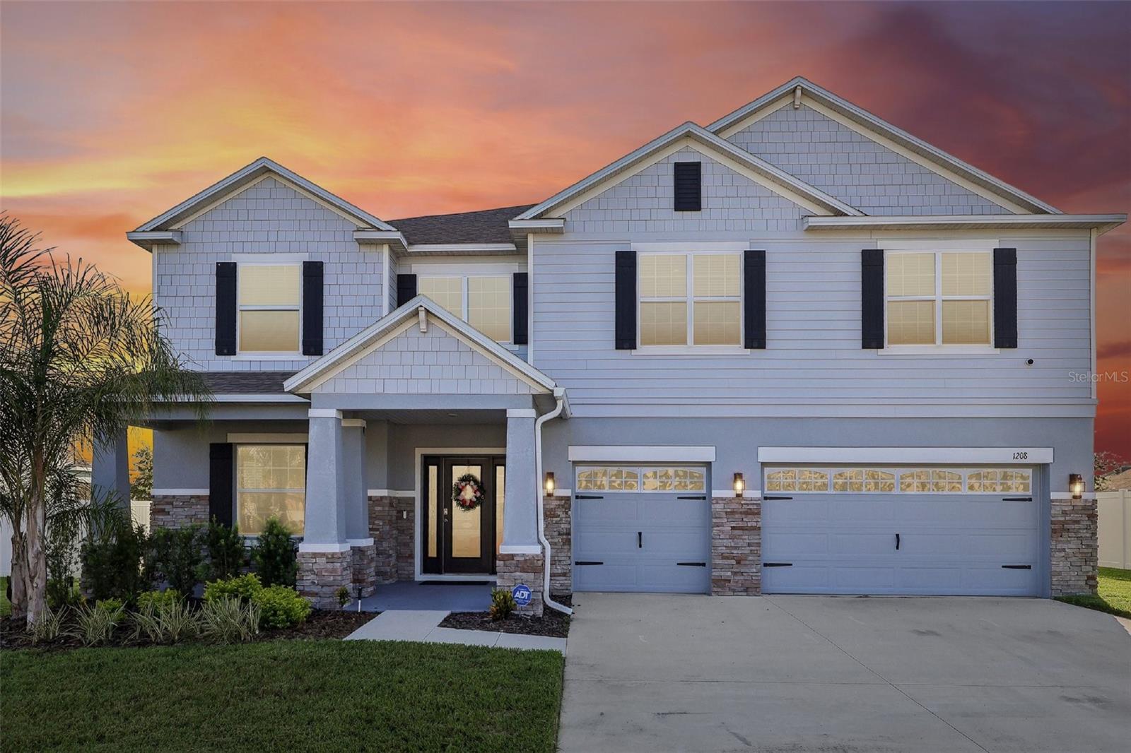 Welcome to this exceptional 2023-built home in the highly desirable Haines Ridge community of Haines City, where modern elegance, impressive space, and thoughtful design come together to create a truly unforgettable home. Sitting on nearly a quarter-acre, this stunning 6-bedroom, 3.5-bath residence offers over 4,100 square feet of beautifully crafted living space with room to accommodate every lifestyle. From the moment you arrive, the home’s impressive curb appeal stands out with a spacious driveway and split 3-car garage. Inside, the welcoming entry leads into a beautifully appointed formal dining room before opening into the expansive heart of the home. The main living area features a bright, open-concept layout connecting the living room, kitchen, and breakfast nook, all enhanced by elegant crown molding throughout. The living room creates a stunning gathering space with two custom built-in fireplaces and a seamless flow into the beautifully designed kitchen, complete with an oversized center island with breakfast bar seating, stainless steel appliances, built-in double ovens, and a large walk-in pantry. One of the home’s most unique features is the main-level sixth bedroom, currently being used as an impressive media room. This flexible space offers endless possibilities as a private guest suite or second primary retreat, featuring an attached full bathroom with a walk-in shower and direct access to the covered screened lanai. Upstairs, a spacious loft provides the perfect area for an additional living space, office, or game room, while the luxurious primary suite offers a relaxing escape with tray ceilings, dual oversized vanities, a walk-in shower, separate soaking tub, and a generous walk-in closet. The covered screened lanai overlooks the expansive backyard, offering a fantastic opportunity to create your own outdoor retreat. Conveniently located near beautiful lakes, golf courses, restaurants, shopping, nature preserves, and major highways, this remarkable Haines Ridge home delivers the perfect blend of luxury, flexibility, and everyday convenience. Mortgage savings may be available for buyers of this listing.