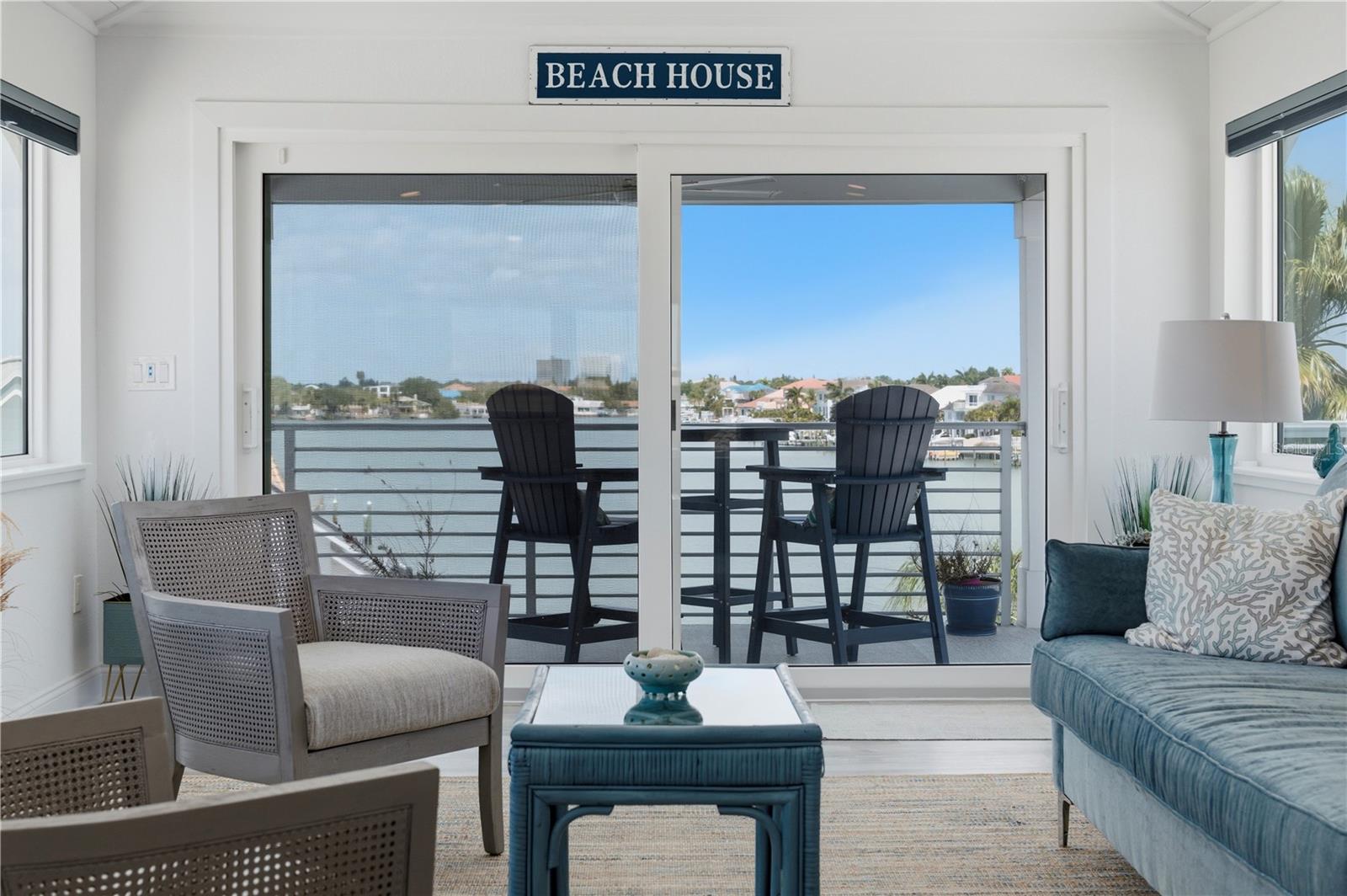 Inspired by the effortless elegance of Barbados, this exceptional coastal retreat blends refined design with a focus on light, views, and seamless indoor-outdoor living. Clean lines, a soft coastal palette, and British-influenced symmetry create a timeless coastal aesthetic, all set within the gated Pasadena Yacht & Country Club—Pinellas County’s only gated, waterfront and golf course community. Ideally positioned  on a spacious corner lot, the home is surrounded by lush tropical landscaping designed for Florida’s coastal environment. A thoughtfully designed reverse floor plan maximizes each level and panoramic water views, with an elevator providing access to all levels— and a floor plan ideal for multigenerational living. The top level showcases a stunning open living space with white tongue-and-groove pitched ceilings, wet bar, and sliding glass doors leading to a 27’ terrace with both covered and open-air areas—perfect for entertaining or relaxing. The main living level features a beautifully appointed kitchen with white shaker cabinetry, quartz countertops, GE Café appliances, and a breakfast bar overlooking the great room and terrace. The spacious primary suite offers a gorgeous en-suite bath and expansive custom closets. This well planned design also offers the opportunity of utilizing the second full bath as his and her primary baths! The first living level includes three additional bedrooms, two baths (including an en suite guest room), and a flexible second living area or office with access to another inviting terrace. Outdoors, the backyard provides a blank canvas for a custom pool design. Additional highlights include five terraces, a four-car garage, pre wired for EV charging, room for workshop and golf cart space, a whole-house generator, metal roof, hurricane windows, Leutron lighting, and 2  expansive paver driveways. For boating enthusiasts, Pasadena Yacht & Country Club also offers a protected 75-slip marina, with boat slips currently available for purchase—providing direct access to the Gulf and a true waterfront lifestyle. (Club membership available at an additional cost) A rare opportunity to enjoy elevated coastal living in one of the area’s most sought-after communities close to downtown St. Petersburg, Florida’s gorgeous, white sand beaches, and a short 35 minute drive to Tampa International Airport.