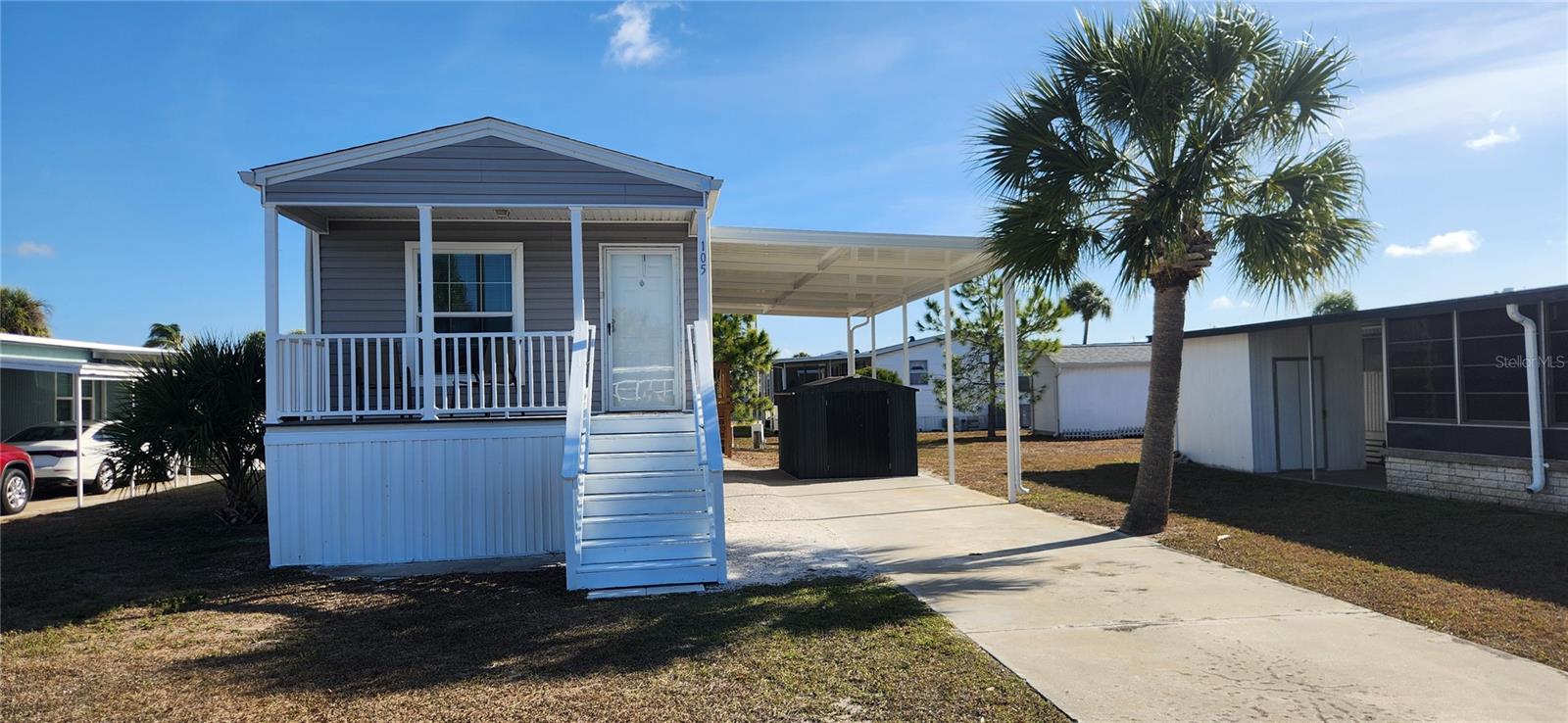 Discover relaxed Florida living in the highly desirable Caribbean Isles Residential Cooperative, a 55+ waterfront community known for its friendly atmosphere and active lifestyle. Built in 2023, this 2-bedroom, 2-bath home offers the benefits of modern construction with a warm, comfortable feel.

Inside, you’ll find a bright and open layout with high ceilings, vinyl flooring throughout, and plenty of windows that allow natural light to fill the space. The kitchen flows easily into the living and dining areas, making it ideal for both everyday living and entertaining. The primary bedroom includes a private en-suite bath, creating a peaceful retreat, while the second bedroom is perfect for guests.
Step outside and enjoy beautiful sunsets from your front porch, a perfect spot to unwind at the end of the day. An extra large covered carport provides generous parking and storage space. The home is conveniently located within a short walk to the clubhouse and community amenities.

Caribbean Isles offers exceptional amenities for residents who enjoy staying active and social. Take advantage of the kayak and boat launch with direct canal access to Tampa Bay, relax in the heated year-round pool, or enjoy classic Florida pastimes like bocce ball, shuffleboard, and horseshoes. The clubhouse features a craft room, game room, pool tables, card tables, indoor shuffleboard, and darts, along with a full calendar of community events, dinners, and dances throughout the year.
Ideally situated between Tampa and Sarasota/Bradenton, this location offers easy access to shopping, dining, beaches, and day-trip adventures.

If you’re looking for a newer home in a welcoming waterfront community, this one is well worth a look. Come see why so many residents are proud to call Caribbean Isles home.