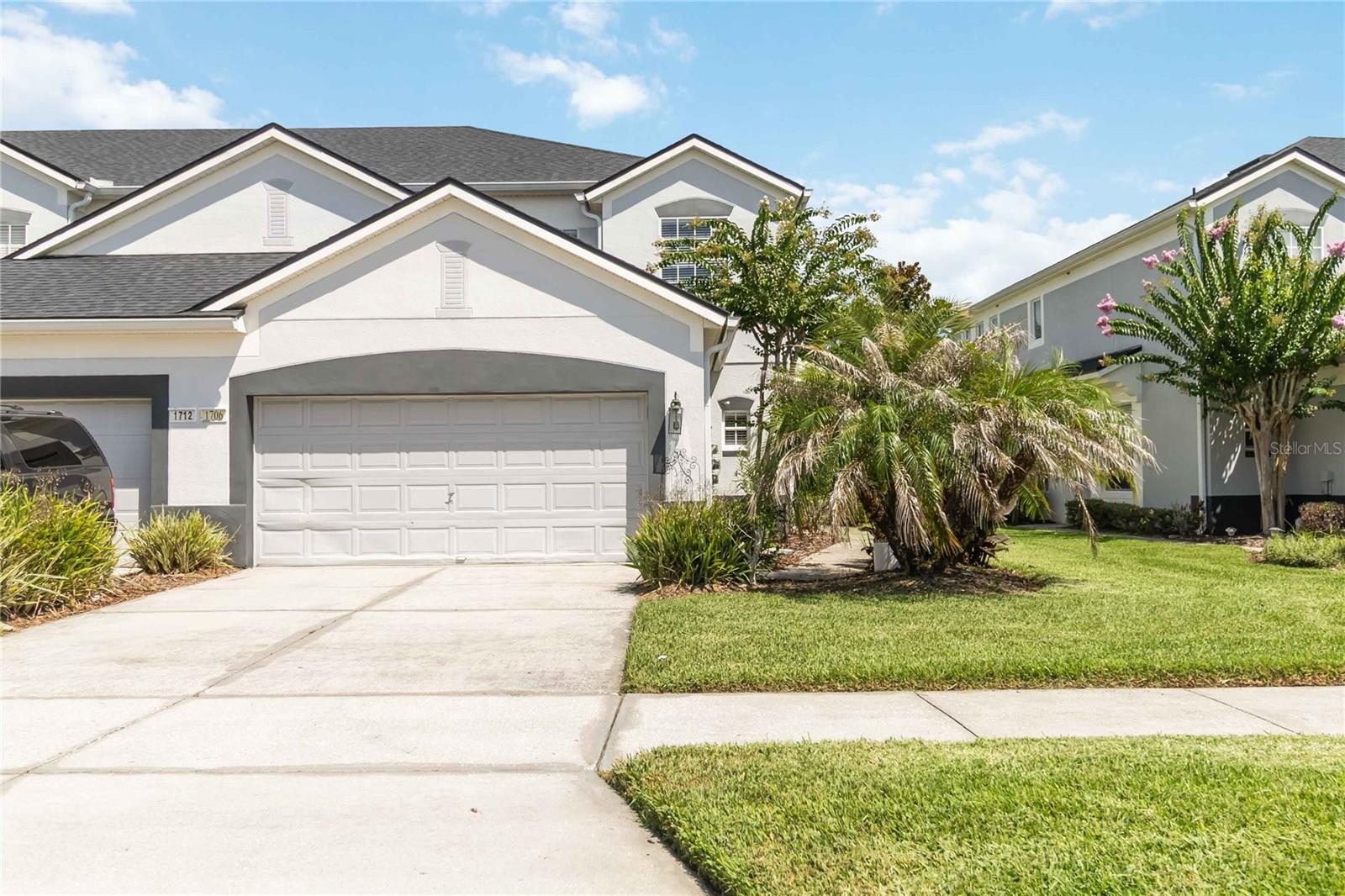 Welcome to this beautifully maintained townhome in the highly desirable 24-hour guard-gated community of Spring Isle at Avalon Park. This spacious floor plan features ceramic tile flooring throughout the first level, and a desirable downstairs bedroom with a full bath and walk-in closet, making it ideal as a guest suite or second primary bedroom. Every bedroom has its own private bathroom, plus a convenient half bath on the main floor. The bright and open living area showcases soaring vaulted ceilings, abundant natural light, and sliding glass doors leading to the outdoor space. The beautiful white kitchen was tastefully remodeled in 2021, features stainless steel appliances, modern backsplash, and ample cabinetry. Upstairs, the flooring has been upgraded to laminate, primary suite offers a walk-in closet with a closet system that provides excellent storage and organization. The en-suite bath with a soaking tub/shower combination. NEWER Roof 2021 and exterior painting 2022, providing added value and peace of mind. Enjoy maintenance-free living with the HOA covering lawn care and access to exceptional amenities, including a resort-style pool, fitness center, playgrounds, and dog park. The oversized two-car garage offers excellent storage with overhead shelving. Conveniently located near UCF, Orlando International Airport, major highways, shopping, dining, medical facilities, and top-rated schools, this move-in-ready home offers the perfect combination of comfort, convenience, and lifestyle.