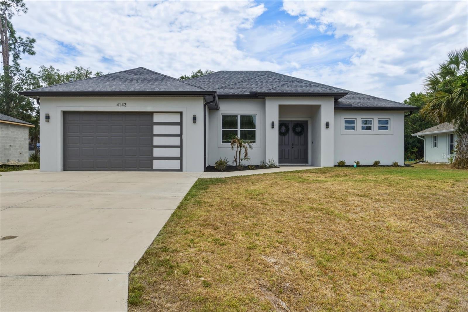 This open concept home offers a thoughtfully designed layout with 3 bedrooms plus an office, 2 bathrooms, and a 2 car garage, all complemented by a spacious screened and covered lanai perfect for enjoying the Florida lifestyle. Inside, you’ll find numerous upgrades throughout, including a whole house Kinetico RO water system, IMPACT windows and doors, an electric fireplace, luxury vinyl plank, and high ceilings with an additional tray ceiling in the primary suite. The kitchen is a standout with double stacked soft close cabinetry, quartz countertops, and contemporary lighting, all opening seamlessly to the main living area. The primary suite features walk in closets, a dual sink vanity, and a beautifully designed walk in shower. Sliders from both the living room and the primary bedroom lead directly to the lanai, creating a true indoor outdoor feel. Additional highlights include a spacious indoor laundry room with upper cabinets, tall baseboards, and a fully FENCED backyard, plus the HOT TUB is included. Ideally located in the growing city of North Port with convenient access to Port Charlotte, you’re just a short drive to Warm Mineral Springs Park, the North Port Aquatic Center, shopping, dining, and beautiful Gulf beaches. This is a fantastic opportunity to enjoy comfort, style, and everything Southwest Florida has to offer.