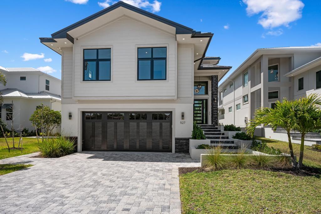 Virtually Staged. Under Construction. Be the first owner of this exceptional new construction home. Enjoy gorgeous, wide Grand Canal views with quick access to Sarasota Bay—a true boater’s dream.  
This home showcases high-end construction at its core, featuring a standing seam metal roof, hurricane-impact windows and sliders, elegant stone detailing, and meticulous craftsmanship throughout—no detail has been overlooked.
Offering 4 bedrooms and 5 bathrooms, including a pool bath and an additional half bath, the layout is both luxurious and functional. Enter through the grand foyer with soaring ceilings, custom trim work, and striking shiplap accents. The open floor plan seamlessly connects the grand room, dining area, and bonus space, all leading to a stunning pool and patio with outdoor kitchen, perfect for entertaining.
The chef’s kitchen is beautifully appointed with stone countertops, custom cabinetry, and premium finishes, complemented by matching stone counters and custom cabinetry in all bathrooms, creating a cohesive and elevated design throughout the home.
Custom wood decking winds its way to the dock, enhancing the waterfront lifestyle. The home also features laundry rooms on all three floors, a spacious loft, and thoughtfully designed primary and guest bedroom suites.

This is a rare opportunity to own a meticulously crafted waterfront residence designed for luxury living and boating enthusiasts alike.