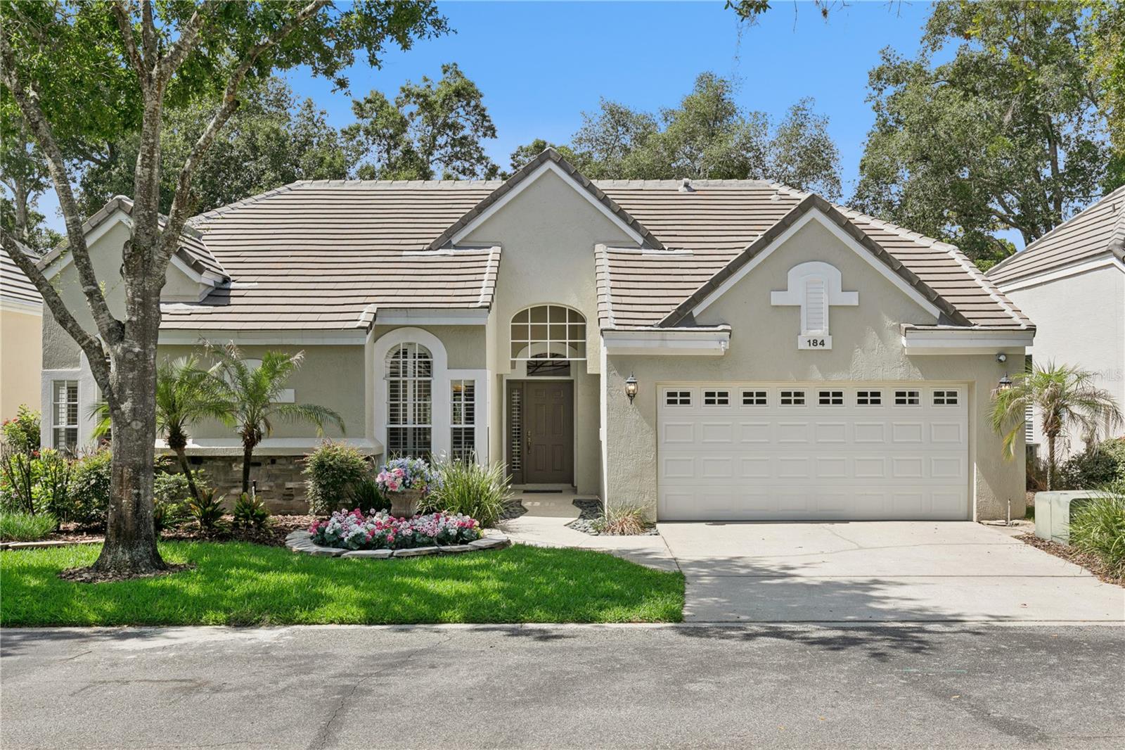 Nestled within the sought-after community of Willowbrook Village at Heathrow, this beautifully appointed residence offers refined living with exceptional attention to detail. The thoughtfully designed floor plan features three bedrooms and two baths, enhanced by designer tile flooring in the main living areas and plush carpeting in the sleeping quarters. Elegant plantation shutters, intricate crown molding, and high-end finishes create a timeless atmosphere throughout. The eat-in kitchen showcases premium appliances, custom-crafted cabinetry, and stunning granite surfaces. The kitchen is open to the light & bright living room & the formal dining area is complemented by a built-in beverage station complete with a wine refrigerator, making entertaining effortless. The generous owner's retreat provides a peaceful sanctuary, while the luxurious ensuite boasts a jetted soaking tub, dual vanities, and a separate glass-enclosed shower designed for ultimate relaxation. Outdoor living is equally impressive with a spacious screened lanai overlooking lush, mature landscaping within the privacy of a fenced backyard. Additional highlights include a two-car garage with built-in storage cabinetry and attic flooring that provides valuable extra space for seasonal items and household belongings. Combining craftsmanship and elegance, this exceptional Heathrow home presents a rare opportunity to enjoy maintenance-free living in one of Central Florida's most desirable gated communities.  Heathrow is Lake Mary's Premier Golf and Country Club Community. It is a private gated community featuring 24-hr. manned security gates, plenty of amenities and zoned to highly rated schools. Enjoy fun activities at Sawyer Lake Park with a large clubhouse, playground, baseball diamond, multi-purpose ball field, lighted basketball court, covered pavilions for hosting larger gatherings and fishing from the pier. Residents can join the Heathrow Country Club and The Legacy Club for the ultimate golfing & dining experience. Members of the Athletic Club have access to 13 tennis courts for year-round play, an Olympic-sized swimming pool overlooking Lake Corso and a fitness facility offering personal training, group classes & massage therapy.  Heathrow is conveniently located near Top Golf, a brand-new medical park, shopping, dining, and entertainment at Colonial Town Park & Seminole Town Center mall. The Seminole Cross recreational trail is close by for bike riding, running and walking. Easy access to I-4, SR417, SR429, and Disney Parks. COME & ENJOY THE HEATHROW LIFESTYLE!  This property may be under audio/video surveillance.