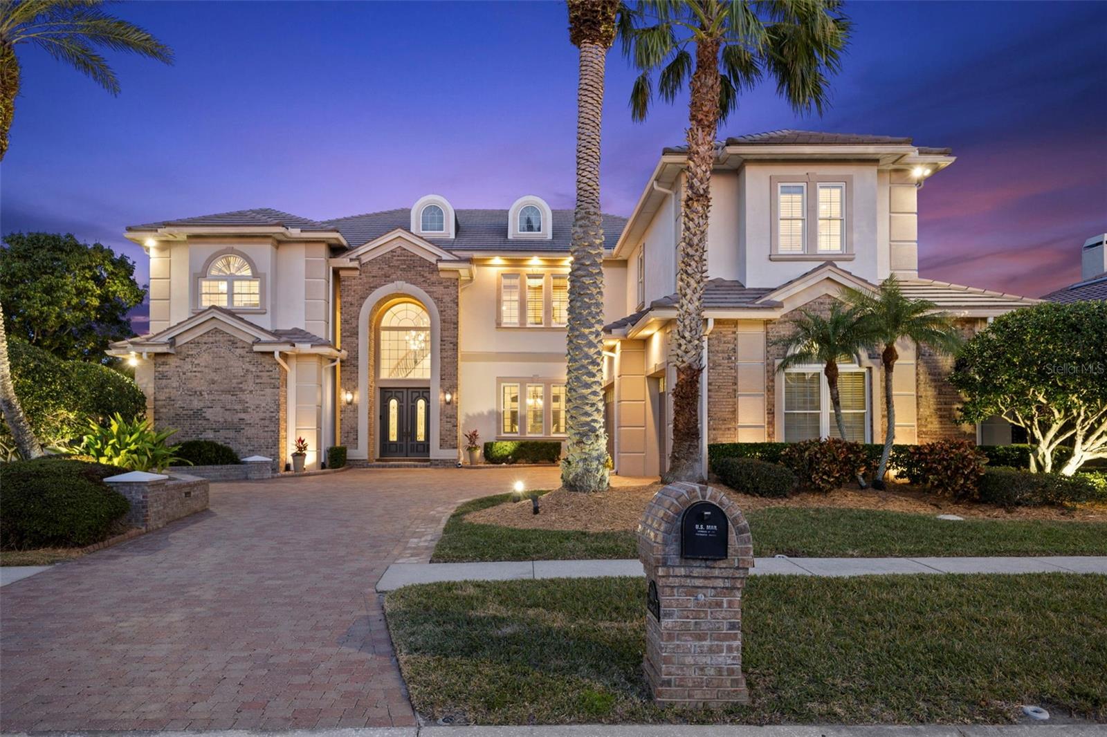 Discover refined elegance with this executive WATERFRONT residence with BAY and GULF ACCESS in the heart of Tampa! Designed for the luxury buyer, this breathtaking WATERFRONT estate combines grandeur and intimacy, epitomizing sophisticated living. Four expansive bedrooms, accompanied by four full and two-half bathrooms, ensure lavish comfort. A home office, theater room, and opulent billiards and bar room extend the luxury lifestyle. Your journey begins through the grand double door entrance, leading into a dramatic two-story spiral staircase foyer. The formal dining room provides an enchanting setting for elegant gatherings. The two-story great room is a blend of luxurious warmth and majestic splendor-highlighted by a gas fireplace with a marble surround, topped with graceful French doors, transoms, and opulent chandeliers. The heart of the home, a chef’s kitchen, has been designed without compromise. This epicurean haven offers a gas range with double ovens, a Miele built-in coffee machine, an island complete with a produce sink, a wine refrigerator, and a workstation. An large walk-in pantry, equipped with a full-sized refrigerator and freezer, delivers unparalleled storage solutions. Adjoining the kitchen, the glamorous half bathroom, with its curved ceiling and marble inlays, emphasizes the home's attention to detail. The BILLARDS & BAR room, reminiscent of vintage allure, features a fireplace, belly-up bar, dual wine fridges, ice maker, and a bar sink-setting the stage for entertaining magic. Conveniences abound with a full pool bathroom adjacent to the HOME THEATER. The MEDIA ROOM invites relaxation in a comforting and intimate space. Upstairs, all bedrooms are thoughtfully positioned. The distinguished primary suite, with natural light and commanding WATER VIEWS, offers a serene sanctuary. Escape to the private seating area for a quiet place to read and unwind. The primary bathroom offers amenities of a wet bar, dual walk-in closets, two water closets, a soaking tub, a makeup vanity, and a frameless walk-in shower. Positioned away from shared spaces, the home office provides privacy while boasting floor-to-ceiling built-ins. Walk along the catwalk to the first additional bedroom, offering an ensuite bathroom, extending the suite-like experience. Each additional bedroom is custom-fitted with built-out closets, meeting every storage need. Discover a BONUS ROOM off the upstairs porch, utilized as a home gym, further enriching your lifestyle. Embrace the Florida lifestyle year-round on your screened-in porch. The OUTDOOR KITCHEN is equipped with an Alfresco gas grill, a hood, and a refrigerator. Overlooking the heated saltwater pool and spa, this luxurious outdoor haven promises endless leisure. The newly extended COMPOSITE DOCK provides a platform to serene FRESHWATER views.  Take the canal to access TAMPA BAY WATERS via a community BOAT LIFT.  Meticulously curated and impeccably maintained, this residence boasts numerous upgrades including a propane tank, generator, central vacuum, instant hot water in the primary suite, advanced whole-house water treatment systems, resurfaced pool and spa, a mosquito comfort system, and new outdoor lighting. As part of an exclusive WATERFRONT GATED COMMUNITY, this magnificent home affords amenities like pickleball courts, a park/playground, and a dog park, all within minutes of the airport and downtown Tampa.  This is luxury redefined, an unparalleled opportunity for those with exquisite tastes.