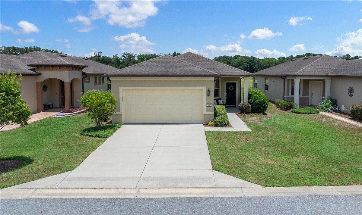 Experience the convivence of resort-style living in this beautifully maintained TURNKEY Noir Coast model, perfectly positioned to capture private, tree-lined views. Located in the sought-after 55+ Stone Creek golf community. This 2 Bedroom, 2 Bath, 2 car garage home offers truly carefree living. Inside, a light-filled, open living plan showcases the well-appointed Kitchen features a casual dining nook, pantry, recessed LED lighting, stainless steel appliances, upgraded cabinetry, a neutral tiled backsplash with granite countertops. A convenient pass-through overlooks the home’s dining area with custom light and gathering room.  The engineered hardwood and soft neutral palette ready for your personal style. Glass sliders in the spacious gathering room open out to the extended screened-in lanai, creating an effortless indoor–outdoor living experience ideal for relaxing or entertaining. The Owner’s Suite provides the perfect space with large windows with serene nature views and walk-in closet offering exceptional storage. The ensuite bath includes a tiled step-in shower with glass doors, double-sink vanity and private water closet. As you discover the Florida lifestyle, allow more time to enjoy your home without too many chores, included in your HOA Fee is Lawn, shrub and tree maintenance, Irrigation system maintenance & repair, Water for lawns and landscaping and amenities. Stone Creek is an active community which offers a fitness center, spa, basketball, dog park, pickle ball, softball, tennis, heated resort-style pool, indoor pool, pool tables, walking & bike paths, catch & release fishing pier. For additional fees a golf course, grille and cafe' is on site. Don't miss out on the opportunity to own this stunning home that is ready to occupy you & only bring your toothbrush! Schedule your showing today!
