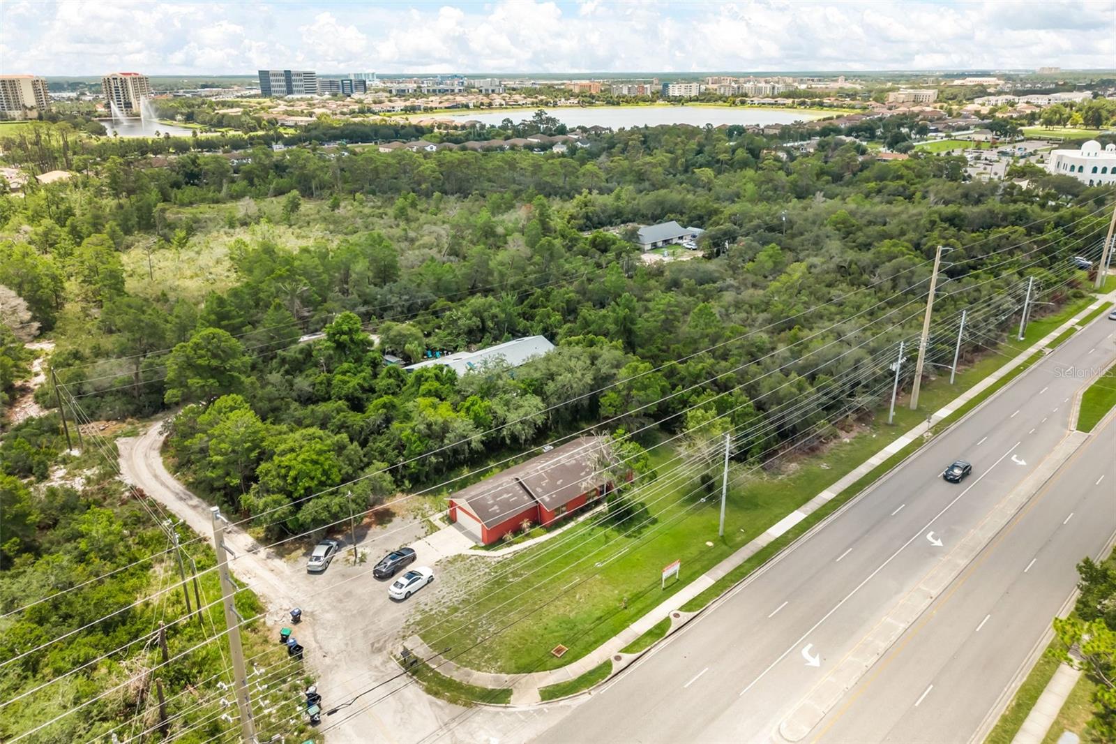 Exceptional commercial/residential package opportunity with frontage along highly traveled S Apopka Vineland Road in the heart of Dr. Phillips/Southwest Orlando. This rare three-parcel offering includes one improved parcel with a freestanding building, plus two additional lots, for a combined total of approximately 26,476 square feet, or 0.61 acres.

The primary parcel totals approximately 13,654 square feet and includes a freestanding building with multiple rooms, bathrooms, a full kitchen, and flexible interior space. The layout offers excellent potential for conversion to professional office, medical, title company, real estate services, boutique retail, service-based business operations, or other commercial/residential use, subject to buyer’s due diligence and applicable approvals.

For an owner-user, this property presents a powerful alternative to leasing in one of Orlando’s most desirable corridors. Operate from a highly visible Dr. Phillips location while owning the land and improvements beneath it, rather than being subject to landlord-controlled rent increases, lease renewal uncertainty, or the limitations of a traditional commercial lease.

The two additional parcels, totaling approximately 5,999 square feet and 6,823 square feet, add valuable land and flexibility for potential expansion, parking, outdoor storage, future development, or long-term investment strategy. Whether used immediately, improved over time, or held for future appreciation, this multi-parcel package creates options that are difficult to find in this location.

Positioned near Restaurant Row, I-4, SR-535, Palm Parkway, major retail, dining, hospitality, residential communities, medical offices, luxury neighborhoods, and Central Florida’s world-renowned attractions, this property benefits from strong accessibility, visibility, and surrounding demand. With reported traffic counts of 30,000+ AADT, the site offers outstanding exposure for a wide range of potential uses.

All three parcels are being sold together as one package. Buyer is responsible for independently verifying zoning, RSTD P-O, utilities, permitted uses, traffic counts, parcel configuration, development requirements, and all information deemed important. Opportunities to own land, visibility, existing improvements, and added parcel flexibility in Dr. Phillips are extremely limited. This is a rare chance to secure a strategic multi-parcel asset in one of Central Florida’s strongest and most recognizable real estate corridors.