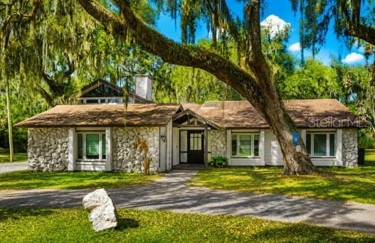 Welcome to one of Kissimmee's most extraordinary income properties — a fully renovated, fully furnished four-unit compound on a private acre with NO HOA, no minimum lease, and short-term rentals allowed. Every space on this property earns.
The showstopper main house welcomes you with soaring beamed cathedral ceilings, a designer kitchen with oversized island, and a wall of glass overlooking your own private INDOOR HEATED POOL — swim year-round, rain or shine, in complete privacy. Three beautifully styled bedrooms, a game room that guests rave about, and a dedicated media room with theater seating make this home an unforgettable stay for vacationing families — or an incredible place to live while your other units generate income.
Steps away, a fully independent 1-bedroom, 1-bath apartment offers its own private entrance, full kitchenette, laundry, great room, and screened porch with spa — a complete home of its own. Above it, a stunning studio cabin retreat features warm wood ceilings, a private balcony under the oaks, and its own jacuzzi — the kind of romantic getaway that books itself. And tucked along a lantern-lit walkway, the one-of-a-kind yurt glamping unit with full kitchenette, bathroom, and loft delivers the unique-stay experience today's travelers search for by name.
Four units. Four income streams. One address — approximately 20–25 minutes from Walt Disney World® Resort with quick access to Universal Orlando, SeaWorld, International Drive, and Orlando International Airport. Live in one and rent three, or operate the entire compound as a turn-key short-term rental investment from day one. Flood Zone X — no flood insurance required by lenders. Sold furnished. Opportunities like this simply cannot be duplicated
