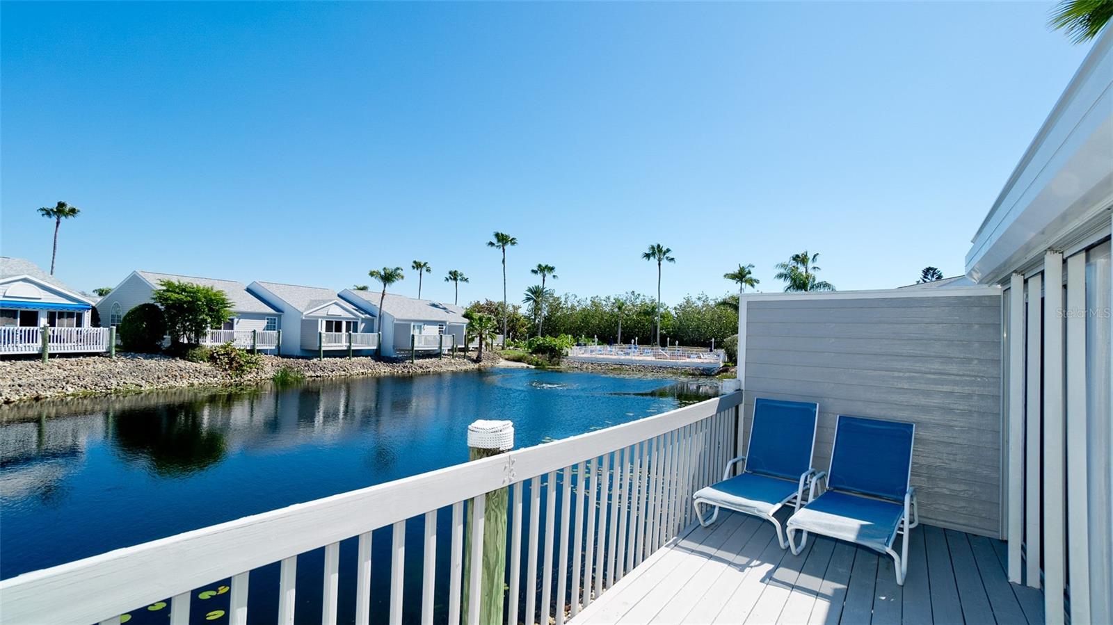 BACK ON MARKET & REDUCED TO $349,000
 This attractive villa with a spacious 2 car garage has 2 bedrooms both with en suite baths plus
a glass enclosed Florida room & large deck overlooking the water lily filled lake.   Updates to this perfect vacation  home
include a recently installed new roof plus new impact resistant skylight.  The handsome kitchen has stainless 
appliances & dark granite counters which compliment the white cabinetry & tile flooring. Both bedrooms have attractive white Plantation Shutters.  A new primary 
bedroom bathroom was installed with a large walk-in shower & vanity.  Electric hurricane shutters were added
on the lanai for protection & manual hurricane storm shutters on the front entry of the villa.  
Located in the exclusive Perico Bay Club, this perfect vacation home is minutes away from Anna Maria Island 
beaches & next door to Robinson, Neal & Perico Preserves . Perico Bay Club amenities include a smaller pool & spa
in this neighborhood, heated in the winter & chilled in the summer, plus a larger Junior Olympic pool next to the Clubhouse which has a fitness, activity rooms, a library & full kitchen. Next to the Clubhouse are tennis & pickleball
Courts, kayak storage & launch.  Perico's 300 acres of manicured grounds include 13 lakes & kayak access to the
Intra Coastal Waterway & Palma Sola Bay. Perico is also home to an incredible variety of birds & marine life:
white pelicans, Roseate Spoonbills, herons, egrets, turtles, hawks & eagles.