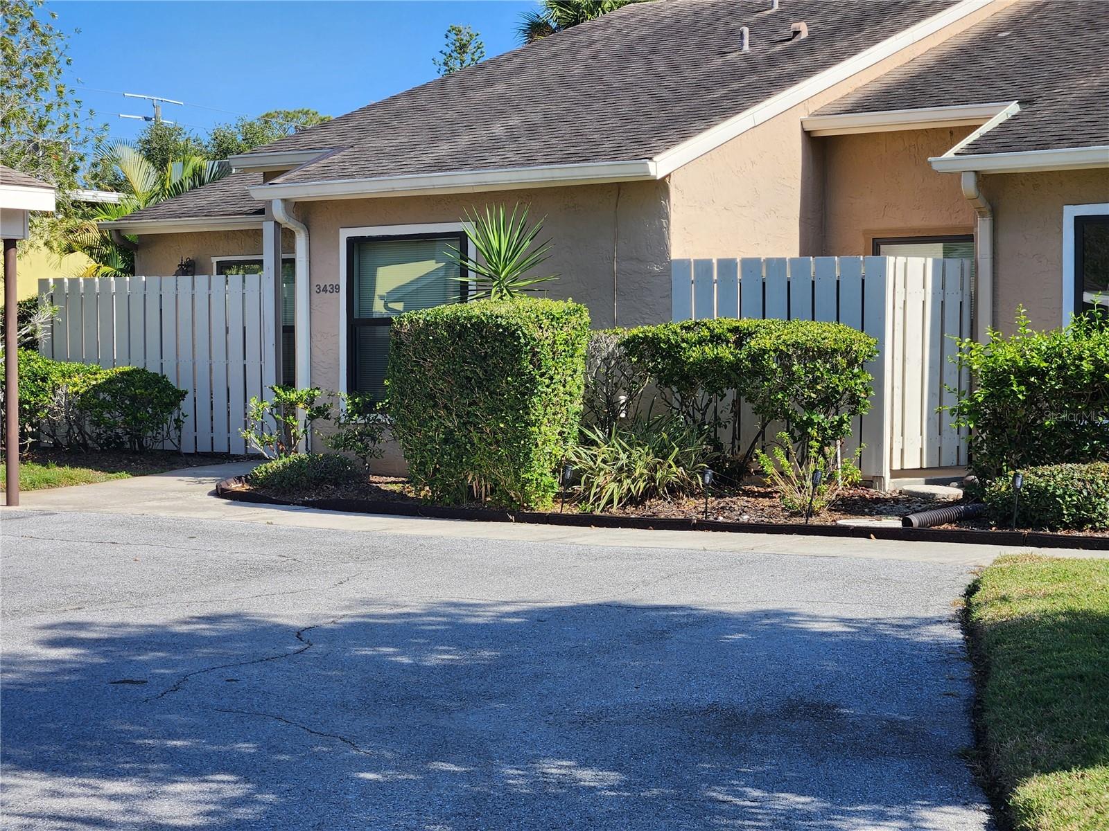 Reduced! 1668 sq. ft. living area PLUS a carport with storage closet priced below $120 per sq. ft.  A charming end-unit villa with real wood floors in the living and dining area. The versatile third bedroom (or bonus room) upstairs, offers a tranquil greenbelt view and HUGE walk-in closet. Spacious open plan with split bedrooms downstairs, a dining room off the living room and a breakfast nook in the roomy kitchen. The furniture is negotiable too!  Tucked deep in Tallywood, a charming, wooded and peaceful village located a few minutes from shopping, a few miles from downtown and a couple more to the beaches. Beautiful wood floors run through the living room and dining room. Lovely vistas of trees and sprawling lawns from several rooms. Set at the end of a quiet cul-de-sac with a carport and storage closet, plus guest parking spaces just a few steps from the front door. Tallywood is a 55+ community with loads of amenities and activities set on 25 acres of lushly treed and green space. Enjoy the spacious screened-in and heated pool. The grand clubhouse offers a fitness center, kitchen, covered lanai and a gas grill.  Compare to another Tallywood 1668 sq. ft. villa that sold in January for $298,000!