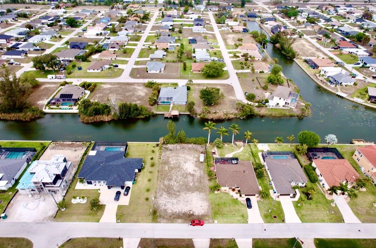 Excellent opportunity to own a cleared waterfront lot in Cape Coral! Situated on a peaceful canal in an area experiencing strong growth and new construction. Utilities including city water, sewer, and electricity are already in place. No mandatory flood insurance required. Perfect for building a primary home, vacation retreat, or investment property. Cape Coral offers over 400 miles of canals and is known for its boating, fishing, golf courses, shopping, and dining, all within close proximity to Fort Myers and the Gulf beaches.
