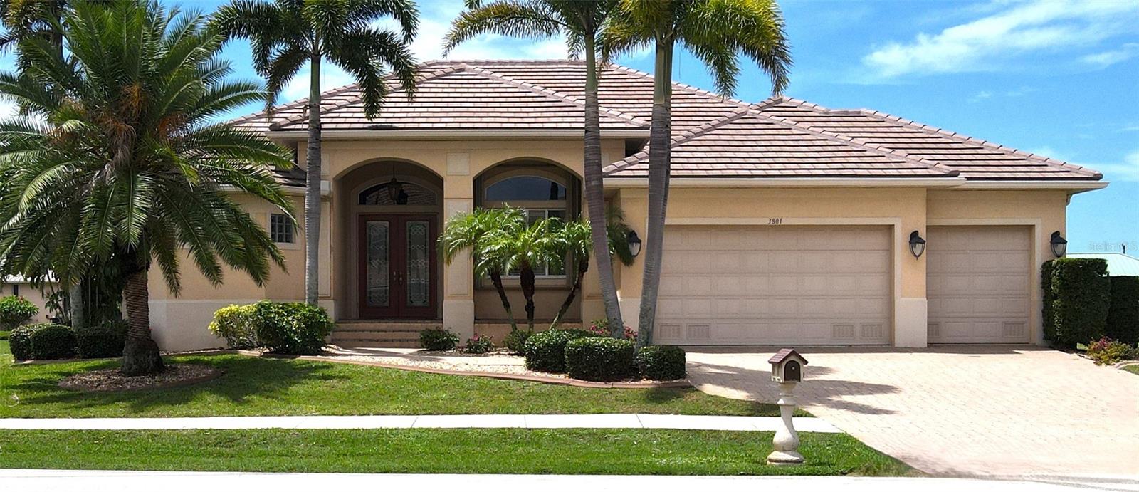 PUNTA GORDA ISLES: Perfectly positioned on the 6th tee box of St. Andrews South Golf Course, this impeccably maintained 3-bedroom, 2-bath pool home with a 3-car garage was built by West Coast Builders and offers the ideal blend of elegance, comfort, and Florida outdoor living.
A paver driveway and walkway lead to double beveled glass entry doors opening to a welcoming foyer and great room featuring tray ceilings with accent lighting, crown molding, recessed lighting, and disappearing sliders that seamlessly connect indoor and outdoor living spaces.
Designed for entertaining, the spacious kitchen showcases custom wood cabinetry, beveled granite countertops, an oversized breakfast bar, center island with prep sink, stainless steel appliances, closet pantry, and a charming breakfast nook overlooking the heated pool, spa, and golf course. A separate dining room provides additional space for hosting family and friends.
The private primary suite offers direct lanai access, dual walk-in closets, separate vanities, a luxurious walk-through shower, and a relaxing soaking tub. 
Guests will appreciate the thoughtfully designed split-bedroom floor plan, spacious guest accommodations, and pool/guest bath with dual sinks and walk in shower.  The third bedroom currently serves as an executive office, ideal for today's flexible lifestyle.
Outdoor living takes center stage with a covered lanai, heated pool and spa, and picturesque golf course views creating the perfect setting for morning coffee, afternoon swims, or evening cocktails while enjoying Southwest Florida's beautiful weather.
Additional features include tile flooring throughout the living areas, plantation shutters, interior laundry room with utility sink, tiled garage with built-in storage, Manibloc overhead plumbing system, hurricane shutters, new roof (2023), and new A/C system (2023).
Most furnishings and fixtures convey with some exclusions, making this truly a move-in ready opportunity. Whether you are seeking aseasonal retreat or year-round residence, this exceptional Punta Gorda Isles home offers the Florida lifestyle you've been dreaming about.   From championship golf and nearby waterfront amenities to charming downtown dining and boating opportunities, every day feels like a vacation in this exceptional Punta Gorgeous home.  ****PLEASE ENJOY THE 3D VIRTUAL TOUR LINK****