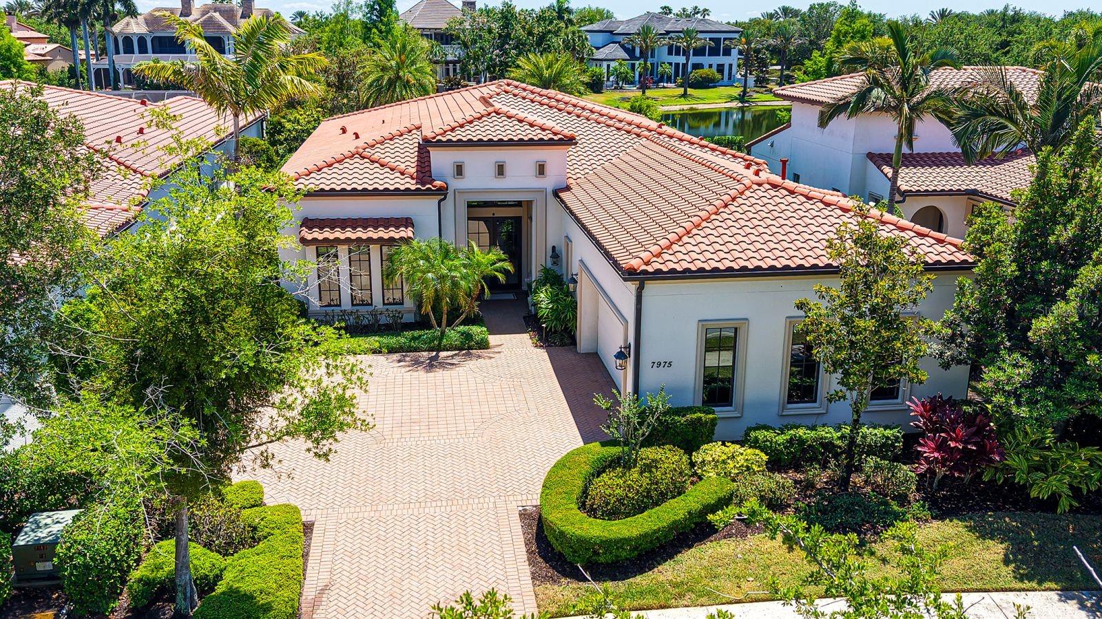 Set behind the gates of the coveted Lake Club in Lakewood Ranch, this award-winning residence captures the essence of refined lakefront living. Inspired by classic Tuscan architecture, the neighborhood impresses with its picturesque bridges, tranquil water features, and winding lakes that create a truly distinctive backdrop.

A three-time Parade of Homes winner, this former Adalia model by London Bay Homes offers an exceptional blend of design and livability. Positioned along the water with over 60 feet of lake frontage, the home is designed to maximize both views and privacy from its expansive lanai, complete with a pool and spa for year-round enjoyment.

Located within the intimate Matera enclave—The Lake Club’s only maintenance-free section—residents enjoy a low-maintenance lifestyle with comprehensive exterior care included, allowing more time to relax and enjoy the surroundings.

Inside, the home unfolds with a thoughtfully crafted floor plan that lives effortlessly. Featuring 3 bedrooms, 3 bathrooms, and a flexible study, the layout provides both comfort and versatility. The study easily serves as a guest space, enhanced with motorized blinds on the French doors for added privacy.

Walls of glass draw you toward the outdoors from the moment you enter, where 10-foot sliding doors frame serene water views and fill the home with natural light. The open great room seamlessly connects to the kitchen and dining areas, creating a space that is equally suited for quiet evenings or lively gatherings. Elevated ceilings and timeless finishes add to the home’s sense of openness and sophistication.

Each bedroom is designed as its own private retreat, including a reconfigured third bedroom with en-suite access. The primary suite offers a peaceful escape, now complemented by newly installed motorized shades for effortless comfort and ambiance.

Built with efficiency and durability in mind, the home is Green Certified and features impact-resistant windows and doors along with whole-home icynene insulation. A series of thoughtful upgrades enhance both function and style, including updated dishwasher, an outdoor kitchen bar fridge, smart climate controls, lanai sunscreens, and a finished garage with epoxy flooring and custom storage.

Life at The Lake Club extends far beyond the home, offering residents access to a private, amenity-rich environment with 24/7 guarded entry. From the elegant clubhouse and resort-style pool to fitness, tennis, pickleball, and scenic outdoor spaces, every detail is designed to support an active and social lifestyle.

All of this is set within Lakewood Ranch, one of the nation’s most celebrated communities, known for its vibrant dining, shopping, top-rated schools, and close proximity to the Gulf Coast’s renowned beaches.