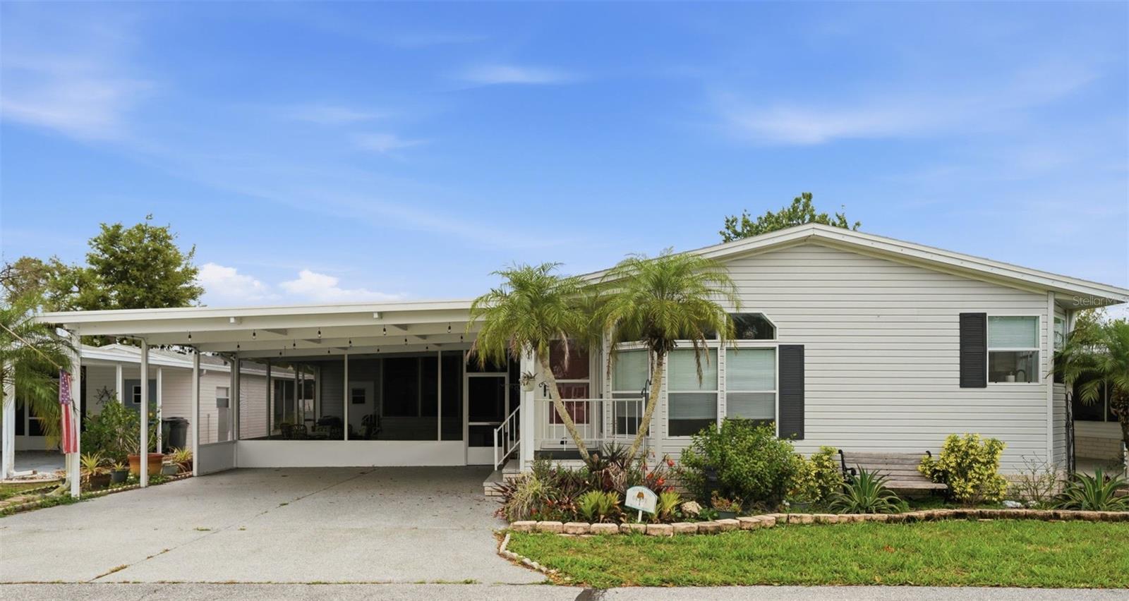 One or more photo(s) has been virtually staged. Welcome to your Florida lifestyle in this beautifully maintained spacious double-wide manufactured home located in a sought-after owner owned, share-owned, 55+, gated community!
This move-in ready home features a spacious, open-concept layout with vaulted ceilings and stylish Pergo wood laminate flooring throughout (total 2312 square feet living space). The large kitchen is perfect for cooking and entertaining, complete with stainless steel appliances and plenty of cabinet space. Large primary bedroom has two walk-in closets, and an en-suite master bathroom. Master bathroom has a full walk-in shower and comfortable soaking tub. Inside laundry room. The home has a newer roof (2022), water heater (2021), AC (2024).
Enjoy year-round relaxation in the large Florida room (24 x14) or unwind in the large screened-in enclosed lanai (292 sqft) ideal for morning coffee or evening breezes. The home also includes a double carport with no-slip epoxy surface, tool shed for extra storage, and is partially furnished for added convenience.
This vibrant golf cart friendly community offers resort-style amenities including a pool, sunning deck, clubhouse, fitness center, tennis and pickleball courts, a fishing dock, and a kayak/canoe launch, direct access to the Myakka River and Gulf—perfect for enjoying the outdoors and staying active.
The community is located close to Wellen Park, Legacy biking and walking trail and nature trails, close to multiple golf courses, tropical beaches, Warm Mineral Springs, public boat launches, and spring training baseball facilities. Convenient access to medical facilities, schools and local amenities. 
Don’t miss this opportunity to own a piece of paradise in a secure, amenity-rich neighborhood!