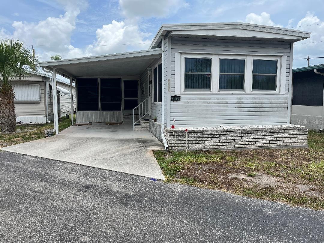Home is situated in a community near to many attractions. Some in the area are beaches, restaurants, shopping. Home features include laminate floors. Newer membrane roof, PVC plumbing. Washer and dryer are out in the oversized shed with a workshop. Comes furnished. The lanai has a bed for overnight guests. In this Community the home and land come together as Real Peroperty. There is no lot rent. A MUST SEE!