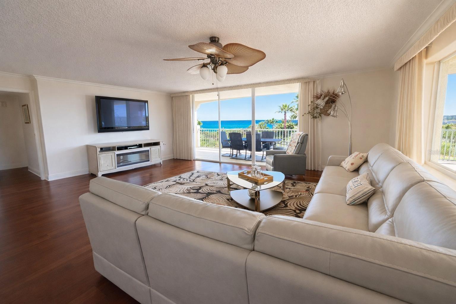 Virtually Staged. ***New Price Adjustment*** Experience costal living at its finest with this stunning ocean-view condo located in the heart of Cocoa Beach. This beautifully designed residence offers 3 bedrooms and 3 bathrooms, combining comfort, elegance and true beach lifestyle.  Wood flooring throughout, bringing warmth and continuity to every space. Enjoy breathtaking views of the Atlantic from your large wraparound balcony, perfect for sunrise coffee or relaxing evenings. The living and dining areas are filled with natural light, creating a seamless connection to the outdoors. The kitchen is designed with wood cabinetry, granite countertops, and stainless-steel appliances, combining durability with a clean elegant look. The generously sized rooms are designated for comfort and privacy. Two en-suite bedrooms with walk-in closets. The primary suite offers views of the ocean, two large walk-in closets, and a spacious master bathroom with two separate vanities for added convenience, a full-size bathtub, and a walk-in shower with multiple shower heads. A large laundry room adds functionality to the home. The den/study room provides additional flexibility and can easily function as a home office, media room, or playroom, adapting to different lifestyle needs. The building provides a gated entrance with ample visitors parking. The unit includes one assigned parking space inside the garage and one additional outside space. Residents enjoy a full suite of amenities: swimming pool and jacuzzi with ocean views, private beach access, a well-designed BBQ area with plenty of tables and seating, and an outdoor fireplace lounge area, a fitness center with a dry sauna and a steam room. This condo is located approximately 1 hour from Orlando International Airport and the Orlando theme parks.  3 miles from the Port Canaveral Cruise terminal, within close proximity to the Cocoa Beach Pier, a local landmark, and just minutes away from a wide variety of restaurants, shops, and everyday conveniences, making this location both practical and highly desirable.