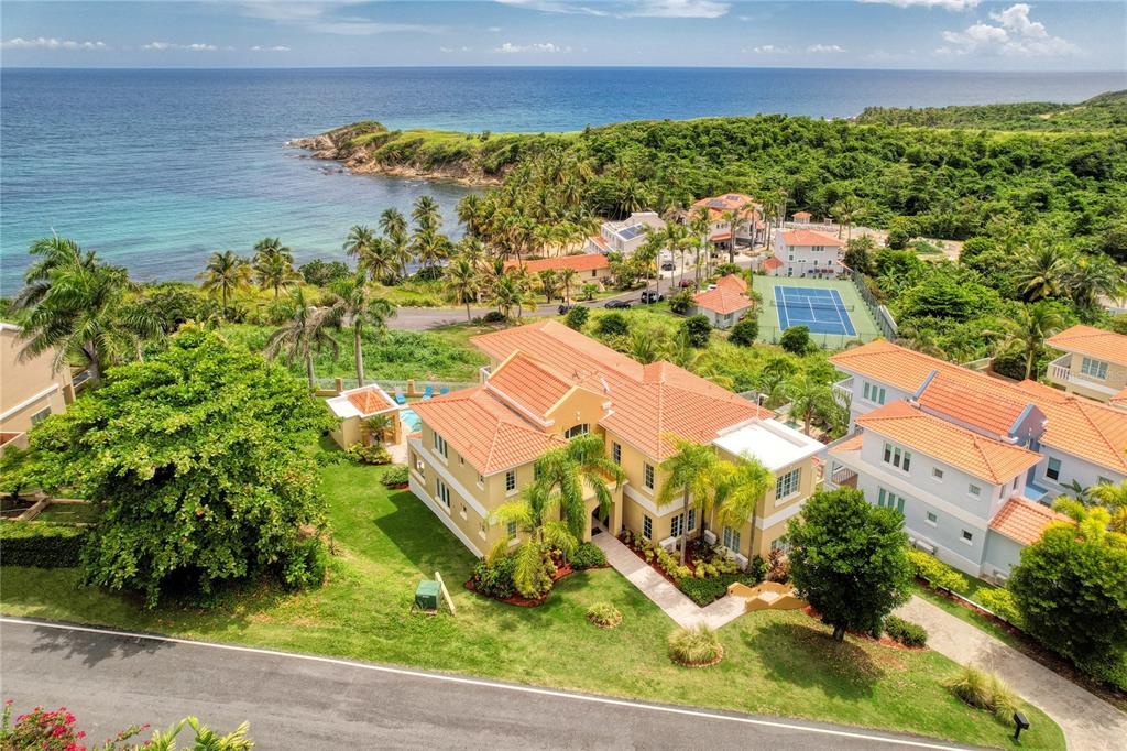 Boasting an exceptionally privileged location on the scenic hillside of Palmas del Mar, this  Mediterranean Contemporary residence is the epitome of tropical elegance. Completely renovated in 2018, this immaculate property offers plenty of natural light, double height ceilings, and an unrivaled view of the ocean. 

Spanning three floors, the expansive layout includes 6 bedrooms, 6 full baths and two partial. Striking details such as a glass wall with Eastern exposure at the foyer and a harmonious and inviting Coastal Design enhance the 4674 sq ft interior. 

An open floor plan and a chef grade kitchen including double built in ovens and a 5 burner gas cooktop thoughtfully set on an ocean facing center island, provide the perfect setting for family gatherings and entertainment.The main level features the dining-room, living room and family room, complete with a wet bar. The lower level includes a wonderfully staged media room and an adjacent guest bedroom and bath. Multiple walk-in closets, balconies and a spacious laundry room complete the well thought-out layout.

The impressive property is highlighted by an ample outdoor space which showcases a pool, spa and covered wet bar with BBQ and a half bath. Golf-cart parking, full power generator and hurricane resistant windows are graciously provided. 53 Shell Castle grants potential owners a greatly coveted Caribbean lifestyle in a warm and relaxed atmosphere. 

Offering the ultimate levels of comfort and convenience, Palmas del Mar is internationally renowned for its top golf courses, tennis courts, equestrian center, private school, restaurants, shopping venues and beachfront location on the southeast coast of the island. Only a 40-minute drive away from San Juan, enjoy the pinnacle of resort living while still being in close proximity to the Metropolitan area.

Annual Hazard Insurance: $3,264.

Annual HOA Fee: $900.