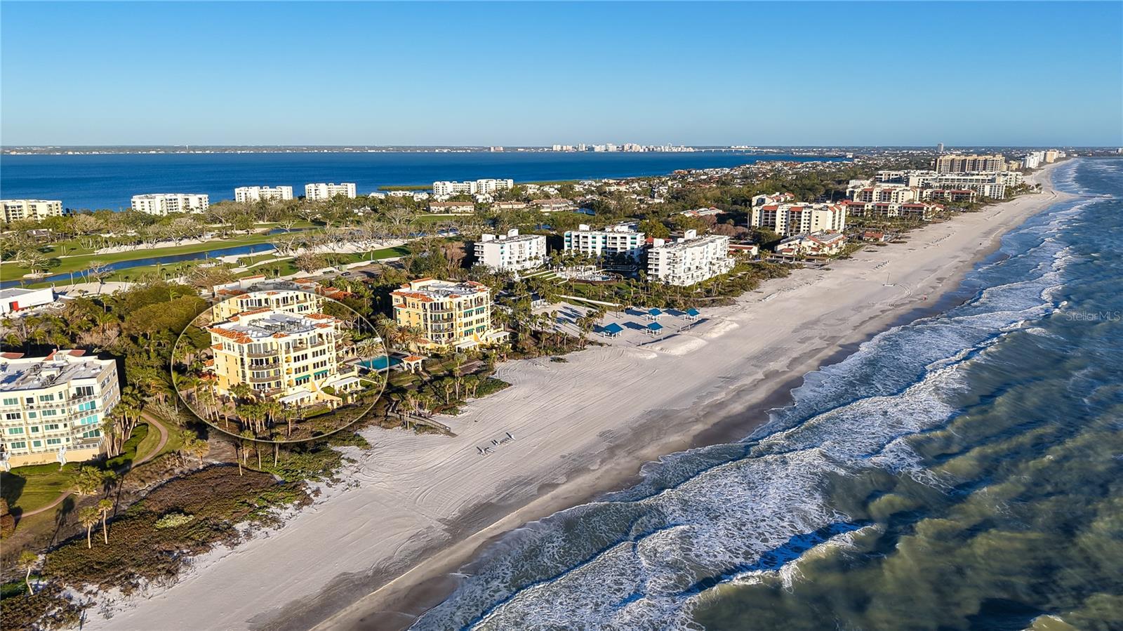 Unparalleled Gulf-front luxury awaits in this rare, third-floor residence at the exclusive En Provence on Longboat Key. With only 21 residences in this sought-after community, this exceptional home offers the privacy of a single-family home combined with resort-style amenities. Spanning nearly 3,500 square feet, this beach getaway shares the floor with just one other residence and features a private, resident-only elevator leading directly from the two-car garage to a grand double-door entry. Panoramic sunset views over the Gulf of Mexico take center stage from the expansive 30-foot beachfront terrace, complete with a summer kitchen and glass railings that maximize the breathtaking scenery. Inside, an open-concept layout seamlessly blends refined living and dining spaces with floor-to-ceiling sliders opening to the terrace. The gourmet kitchen overlooks the family room and is designed with all-white custom cabinetry, a Butler’s pantry, planning desk, and a cozy breakfast nook. The primary suite is a private sanctuary, featuring uninterrupted Gulf views, terrace access, a massive custom walk-in closet, and spa-inspired en-suite with dual vanities, soaking tub, and walk-in shower. Two guest bedroom suites are tucked away on the opposite side of the residence, each with their own en-suite baths, walk-in closets, and access to the east-facing balcony. The versatile third bedroom, currently used as a den, adds to the home’s functional layout. Set on six acres of meticulously landscaped beachfront property, En Provence provides a 24-hour manned gatehouse, on-site management, and concierge services. The community’s Gulf-side deck features a heated swimming pool, spa, and trellis-shaded seating areas. Residents enjoy exclusive access to a clubhouse with a lounge, private dining room, catering kitchen, fitness center, juice bar, and dual locker rooms. A private boardwalk leads directly to the pristine shores of the Gulf of Mexico. Located just minutes from St. Armands Circle’s world-class shopping and dining, the Longboat Key Club’s championship golf courses, and the vibrant arts and culture of downtown Sarasota, this beachfront retreat offers the ultimate blend of sophistication and serenity.