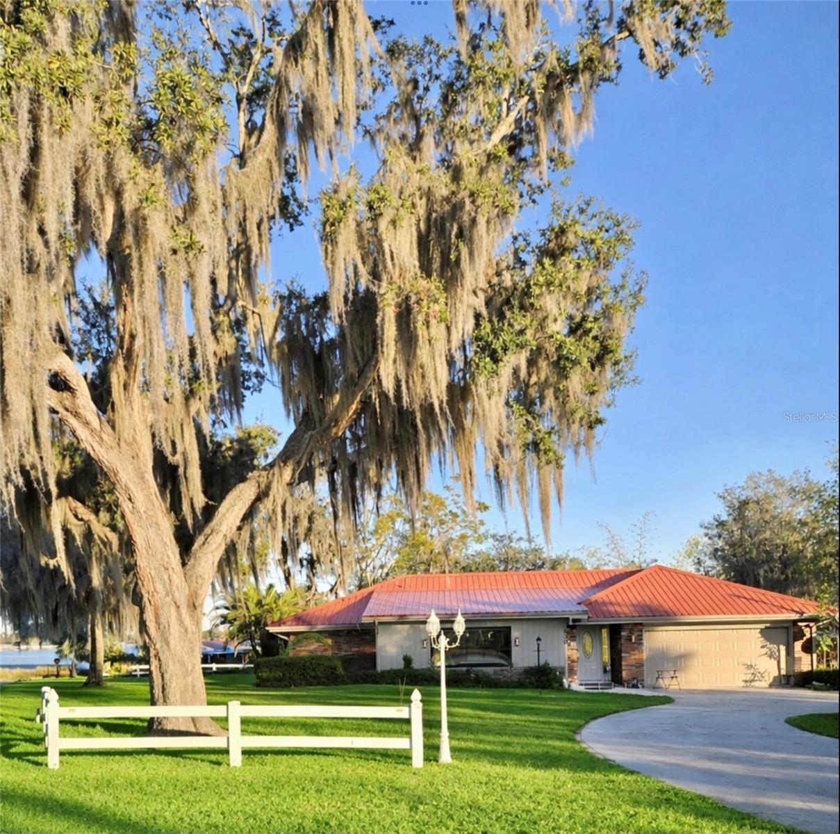WELCOME TO YOUR PRIVATE LAKESIDE SANCTUARY! Perfectly positioned between Lake Clay and Lake Blue, this extensively renovated home blends modern luxury, energy efficiency, and peaceful Florida living, with scenic lake views from multiple rooms throughout the house.
The home has been thoughtfully upgraded from top to bottom, offering true move-in-ready confidence. 
Enjoy all-new impact-rated windows with hurricane shutters, a fully updated electrical system with new electrical box, new plumbing, and two new drain fields, delivering long-term reliability and peace of mind.
At the heart of the home is a brand-new gourmet kitchen, complemented by new flooring, crown molding throughout, all-new lighting, ceiling fans, and motorized blinds. 
The primary suite features a fully renovated spa-style bathroom, complete with a heated toilet with bidet, while a new high-efficiency AC system with new ductwork ensures year-round comfort.
The family room is a true showpiece, featuring a custom built-in indoor waterfall and a sleek electric fireplace with heating capability, creating a warm, modern ambiance and a striking focal point—all while enjoying views of the surrounding lakes.
Designed for energy efficiency, the home includes a leased solar system with an average electric bill of just $93.15/month, plus a mini-split unit in the terrace for added climate control.
Additional features include a garage with a full screen enclosure to keep insects out while allowing airflow, a brand-new jacuzzi, new shed, new carport, and new gutters with leaf-filter system.
Surrounded by natural beauty and offering views of both Lake Clay and Lake Blue from many areas of the home, this property delivers a tranquil lifestyle with modern comforts, ideal as a primary residence, vacation retreat, or investment opportunity.
A rare opportunity to own a fully upgraded home with dual-lake views, this one truly stands out!