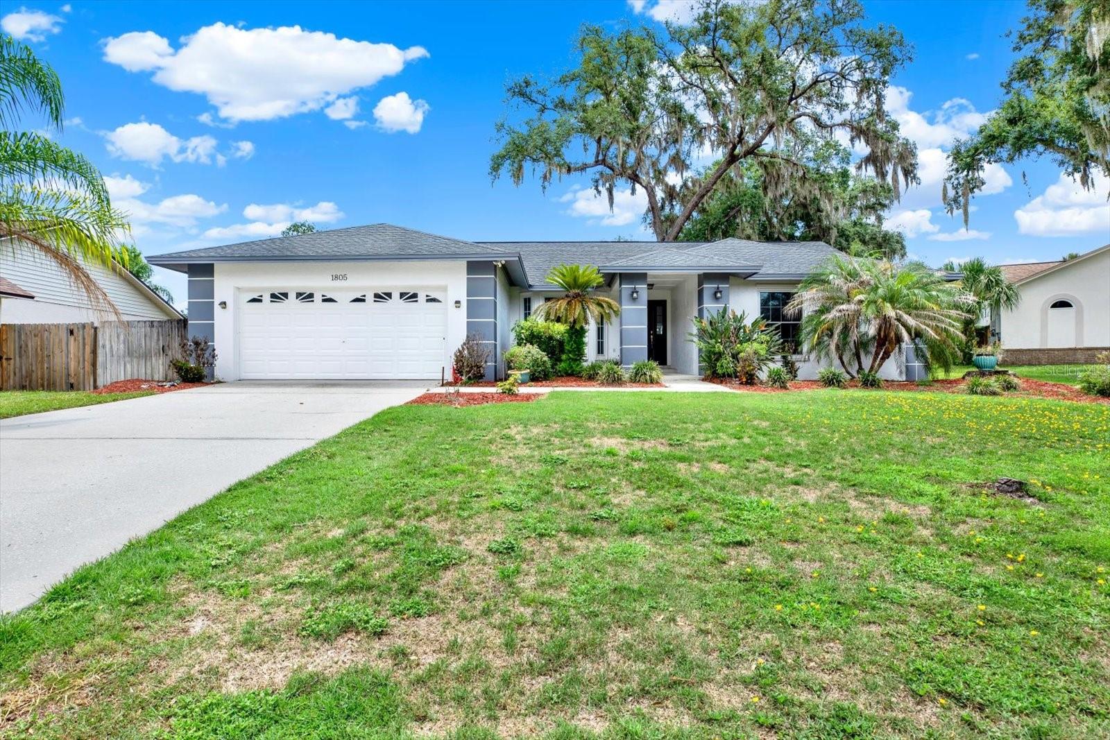 Tucked away in one of Brandon's best-kept secrets, this beautifully updated 4-bedroom, 2-bath pool home offers the perfect blend of modern updates, timeless charm, and an unbeatable location. Situated on a quiet cul-de-sac in the desirable Lakeview Village community, this home welcomes you with incredible curb appeal, mature oak trees, and a spacious 2-car garage.  Step inside to soaring ceilings, an open and airy floor plan, and luxury flooring throughout the main living areas. The fully renovated kitchen is the heart of the home, featuring rich espresso cabinetry, quartz countertops, designer tile backsplash, stainless steel appliances, oversized breakfast bar, and contemporary lighting that opens seamlessly to the living and dining spaces—perfect for entertaining.  The spacious family room showcases vaulted ceilings, a cozy fireplace, and large windows overlooking the sparkling screened pool and oversized backyard. The split-bedroom floor plan provides privacy, while the primary suite offers direct access to the lanai and features a beautifully remodeled spa-inspired shower completed in 2023.  Major updates provide peace of mind, including a new roof (2021) and new A/C (2021), allowing you to simply move in and enjoy.  Outside, you'll love relaxing by your screened-in pool surrounded by mature landscaping and one of the neighborhood's signature towering oak trees, creating a private backyard retreat with plenty of room for pets, play, or entertaining.  NO FLOOD ZONE, NO CDD. Very Low HOA. Homes in this hidden gem of a Brandon neighborhood rarely become available. Conveniently located near shopping, restaurants, parks and schools. Minutes to Interstate 75 for convenience.  Only 30 minutes to Tampa International Airport. This one truly checks all the boxes.  Book your private showing now!