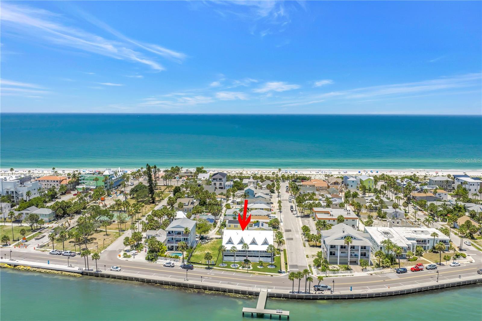 Coastal Sophistication in Historic Pass-a-Grille defines this wonderfully unique 2 BD/2 BA Multi-Level Luxury Townhome. Experience the pinnacle of coastal elegance in this impeccably Furnished three-story waterfront sanctuary. Perfectly positioned on the coveted, historic peninsula of Pass-A-Grille, this residence offers an unparalleled dual lifestyle framed by the azure Gulf of Mexico on one side and the vibrant Intracoastal Waterway on the other. The bright, airy kitchen is a showpiece of modern coastal design, featuring stainless steel appliances with gold accents, coordinating gold hardware on the well designed cabinetry and stone countertops that elevate the entire main living level. This open-concept space flows effortlessly onto the living area and private balcony overlooking the deep-blue waters of the Pass-a-Grille Channel, where passing yachts and gentle tides create a living masterpiece. The top-tier primary ensuite bedroom serves as a private retreat, complete with its own secluded balcony, perfect for morning coffee or evening wine as the sky transforms with Florida’s legendary sunsets. The ensuite bath features nautical style porthole window that frames tranquil views of the Pass-a-Grille Channel, offering a unique vantage point to watch boats glide past from this elevated level. The ground level offers a seamless indoor outdoor transition with a 1-car garage, refreshing outdoor shower, fenced patio deck, and a versatile bonus space ideal for a private gym, beach cabana, artist’s studio, or customize to any personalized retreat the new owners envision . The garage and bonus area is not included in the heated living square footage.  Pass-a-Grille is more than a location, it is a beloved beachside community where golf carts are the preferred mode of travel and the pace of life slows to match the tides. You are steps from iconic local restaurant favorites including the Sea Horse, Brass Monkey, Paradise Grille, The Wharf, Don CeSar, and The Hurricane. Enjoy the pristine sands of Pass-a-Grille Beach or stroll the waterfront sidewalk along the Pass-a-Grille Channel. Private community amenities include tennis, pickleball, basketball, shuffleboard, a fishing pier, and seasonal outdoor concerts. Furnishings have been thoughtfully curated and are included for an effortless, immediate transition into the luxury coastal lifestyle. Schedule your tour and experience the life you’ve always imagined.