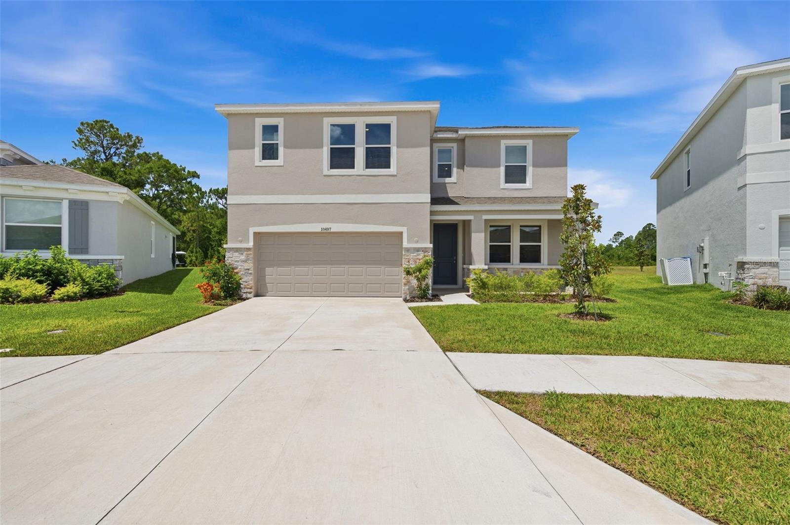Virtually Staged. Welcome to luxury living in the highly sought-after master-planned community of Angeline in Land O' Lakes! Be the very first residents to enjoy this brand-new DR Horton Talbot model, offering an impressive 3,561 square feet of thoughtfully designed living space with 5 bedrooms, 3.5 bathrooms, a private office, oversized bonus room, and 2-car garage. This stunning two-story home features a versatile floor plan ideal for multigenerational living, with a first-floor guest suite complete with its own ensuite bathroom featuring both a soaking tub and separate shower. Upstairs, you'll find the spacious primary suite along with the remaining bedrooms and an expansive bonus room perfect for a media room, playroom, or additional living space. The heart of the home is the beautifully appointed kitchen showcasing elegant quartz countertops, abundant cabinetry, and brand-new Whirlpool stainless steel appliances. The open-concept design flows seamlessly into the spacious great room, highlighted by an attractive tray ceiling and abundant natural light. A dedicated front office with French doors provides the perfect work-from-home space. Modern white oak luxury vinyl plank flooring spans the entire first floor, while plush brand-new carpeting adds comfort throughout the upstairs living areas. Step outside to the screened lanai and enjoy peaceful pond and conservation views with no rear neighbors. Situated on a premium corner bend lot, this home offers a larger pie-shaped backyard and enhanced privacy. Lawn care, professional property management, and high-speed internet are all included, making for a truly maintenance-free lifestyle. Residents of Angeline enjoy access to an innovative, wellness-focused community featuring parks, playgrounds, scenic walking trails, community gathering spaces, and unique agricultural amenities including a community garden with resident garden plots and a chicken coop providing fresh eggs. The popular Wild Thyme Café & Market offers a convenient place to grab lunch, meet neighbors, and enjoy community events. Families will appreciate the convenience of the Angeline Innovation Academy, a premier STEAM-focused school serving grades 6-12, as well as the nearby Angeline Country Day School. Ideally located just minutes from SR-52, the Veterans Expressway, and the future Moffitt Cancer Center campus, this exceptional home offers the perfect blend of luxury, convenience, and community living. Don't miss this opportunity to lease one of Angeline's newest and most desirable homes!