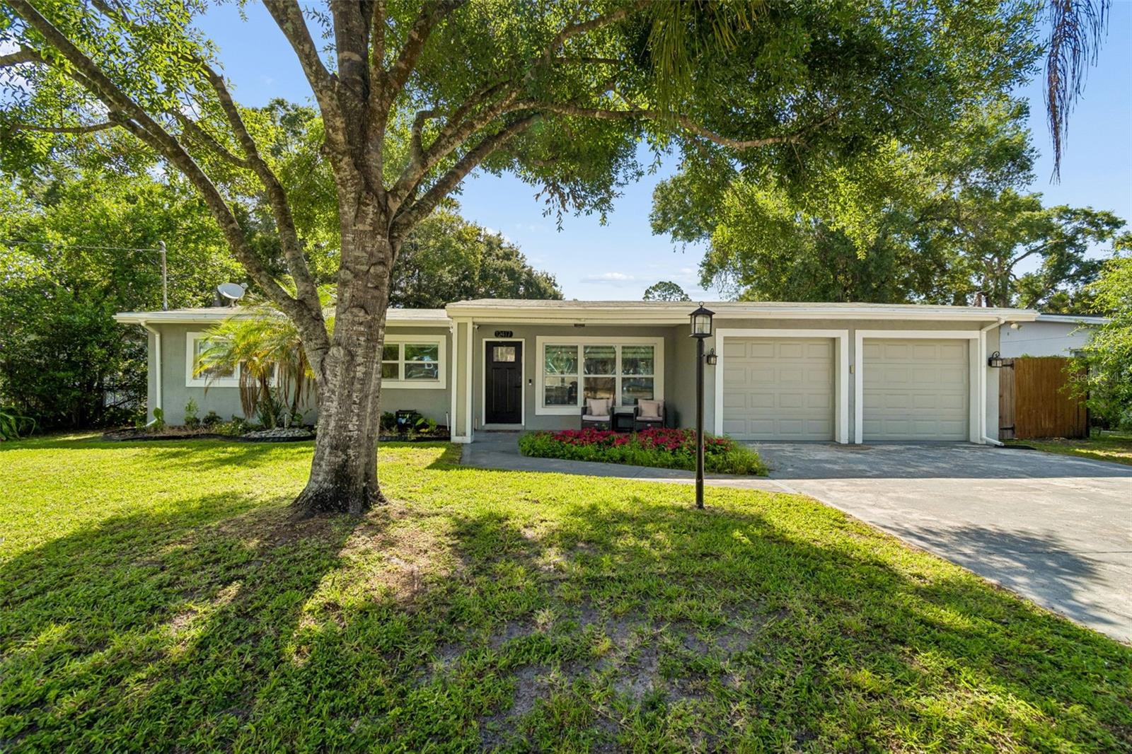 Welcome to your private Florida retreat POOL home with NO HOA and NO CDD on a generous lot! This single story, open concept 3 bedroom, 2 bath home was made for easy living and effortless entertaining. At its heart is a true entertainer's kitchen with expanded cabinetry, stone counters, stainless appliances, two-sinks and two dishwashers ideal for serious home cooks and entertainers. A sliding glass door opens to your backyard oasis: a sparkling pool wrapped in paver decking, a covered patio, and a removable pool safety fence, all set against a fenced backyard. Inside, durable laminate and ceramic tile flow throughout, elevated by all new window treatments and modern lighting. The primary suite and hall bath shine with updated tile and stone. Enjoy peace of mind with a security system and irrigation. Minutes from USF, Busch Gardens, AdventHealth, I-275, and downtown Tampa.