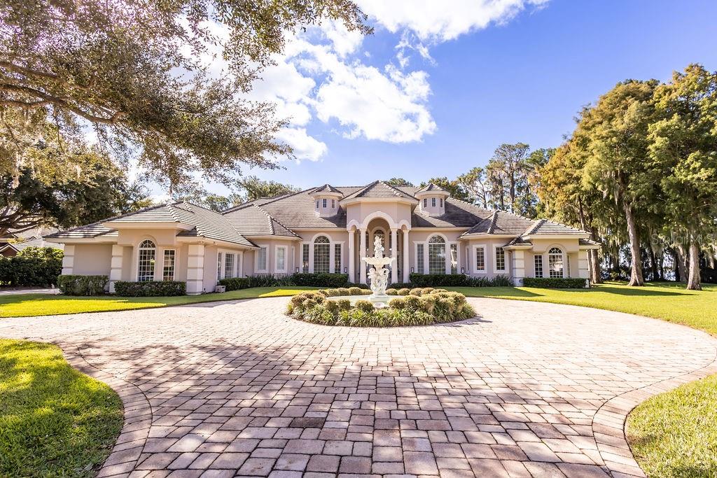 This exceptional estate, situated within the renowned guard-closed gated Cypress Point community on the stunning Butler Chain, is truly unique. Upon entry, you're greeted by breathtaking views of the pristine Lake Sheen spanning 167 feet. The grand foyer showcases 20-foot ceilings and expansive windows, filling the home with natural light. Perfect for hosting, it boasts a formal dining room and game room, both adorned with exquisite imported chandeliers. The kitchen is a chef's paradise, featuring a built-in gourmet coffee machine, gas cooktop, professional steamer, and top-notch appliances. 4 suites downstairs and 2 suites upstairs. The master suite is a serene retreat, leading to a spacious closet and a luxurious spa bathroom with a steam shower and views of Lake Sheen. A full cine room, a game room and a library. Outdoors, you'll find a resort-style pool, hot tub, summer kitchen, covered seating area, and fire pit, all overlooking the lake. A private dock provides access to the Butler Chain of lakes and a delightful spot to enjoy sunsets and  Disney fireworks.
Extra features: Ring Camera Front Door
TP-Link KASA Smart Switches and Dimmers throughout house
TP-Link KASA Smart Switches, Dimmers, and Color LED Bulbs in 5 bedrooms 
Automatic Shades in 3 bedrooms 
Automatic Curtains in Master Bathroom
Smart Door Lock (Front door + garage)
Smart HVAC Honeywell Home System
Sonos Home Audio Speaker System (House:Bedroom 1, Game Room,Bedroom 2, Master Bedroom+Bathroom, Outside (over fireplace area/entire covered area) (speaker+soundbar+sub+amp system in movie theater) + (sound bar in game room).
This is a rare opportunity to acquire a fully remodeled dream home in Cypress Point – a true must-see.